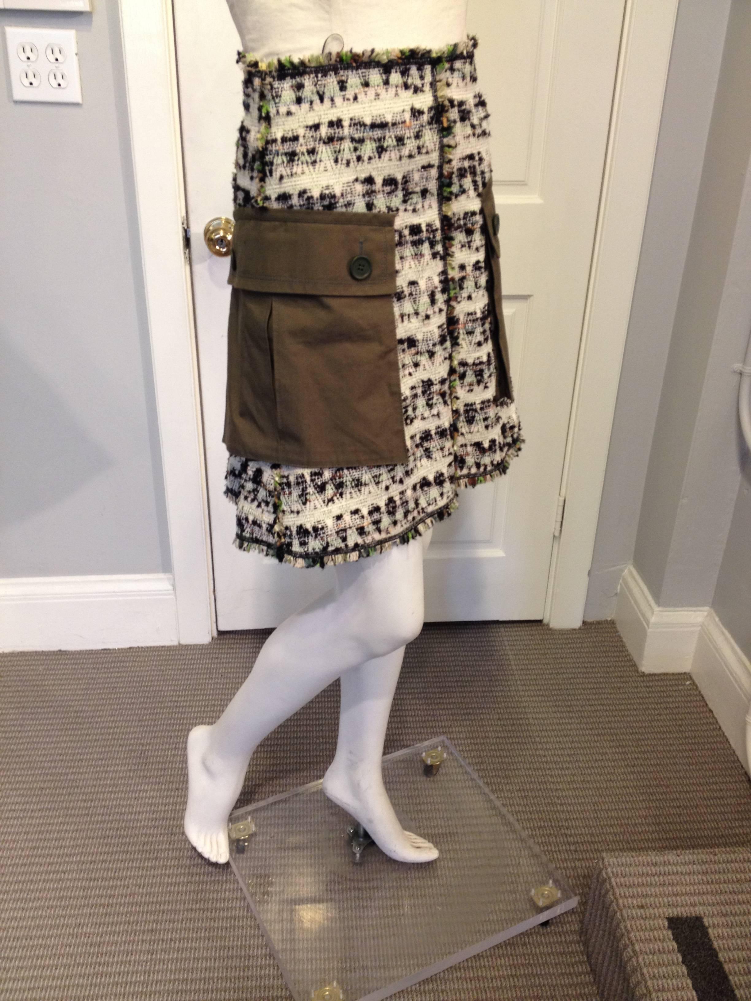This Louis Vuitton skirt takes inspiration from the army and makes it chic. It's made out of a cream tweed lined with black threads and sprinkled with flecks of green, olive, caramel, and brown. The a-line shape is accentuated by voluminous oversize
