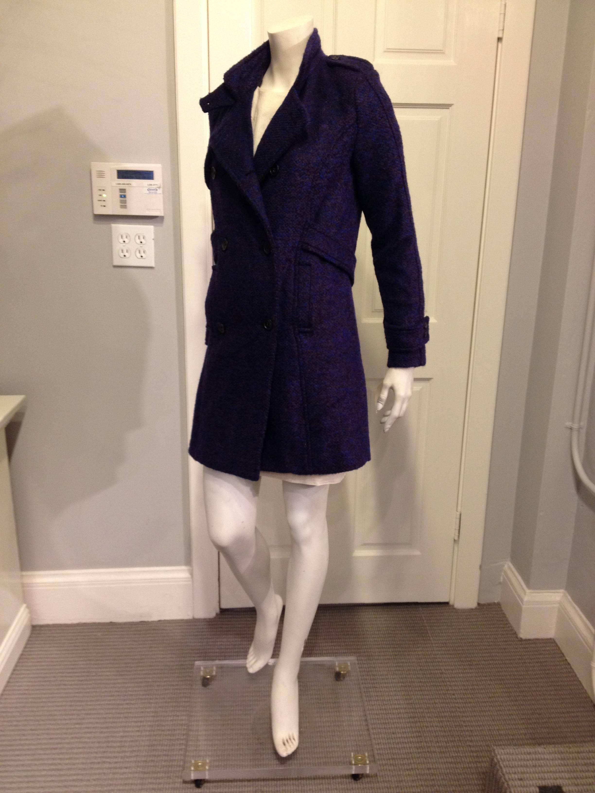 Styled like a trench coat with button epaulets, a double-breasted front, notched-lapel collar, and a loose fixed belt, this piece is warm but stylish, comfortable but striking. Soft plush tweed is so gorgeous in this deep royal purple with flecks of