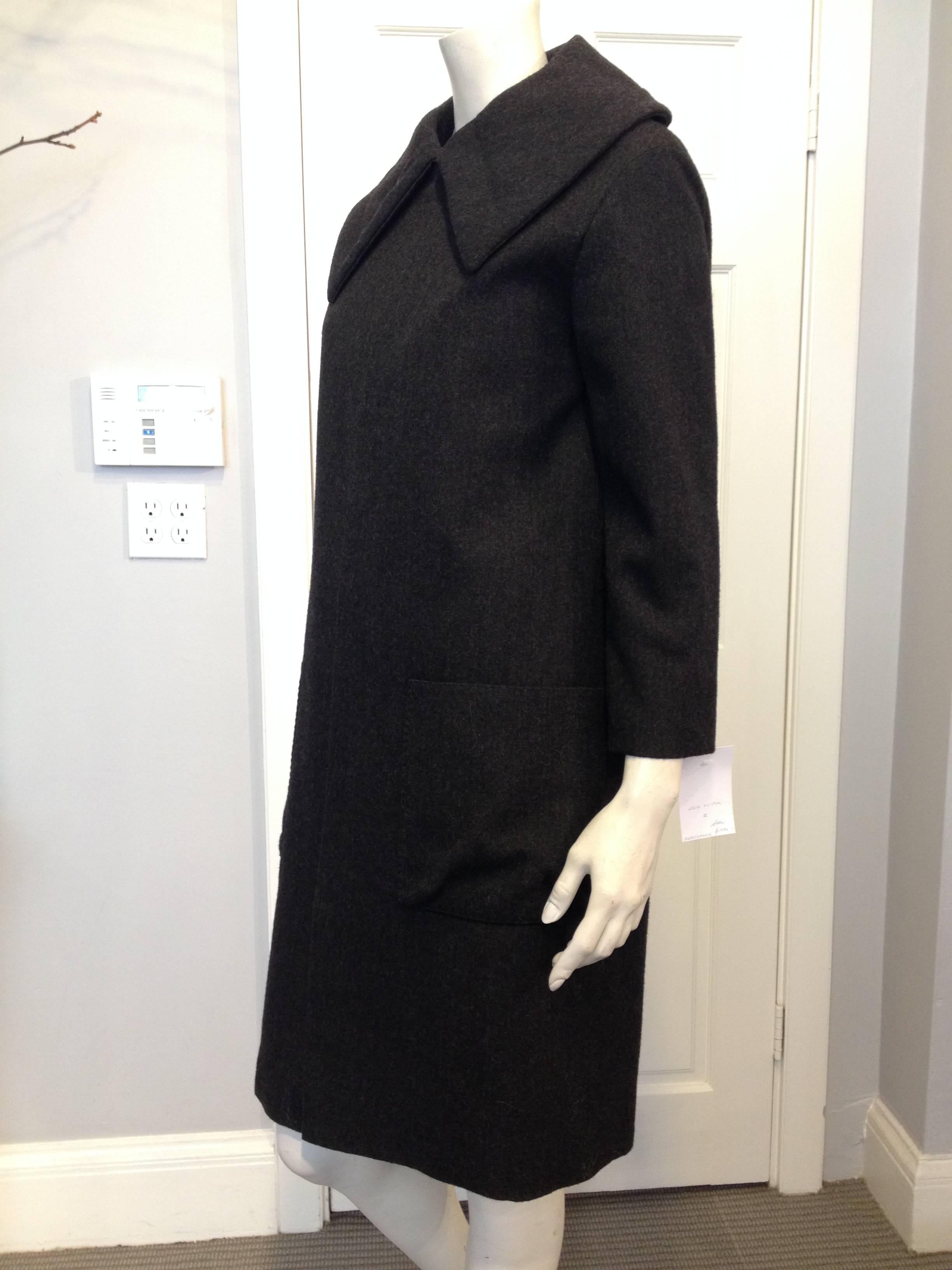 Pure glamour - this impeccable Louis Vuitton wool coat is the epitome of style. It is cut classically with a grand collar, wide sleeves, and a very subtly voluminous body, a skillfully shaped piece that will look as chic in twenty years as it does