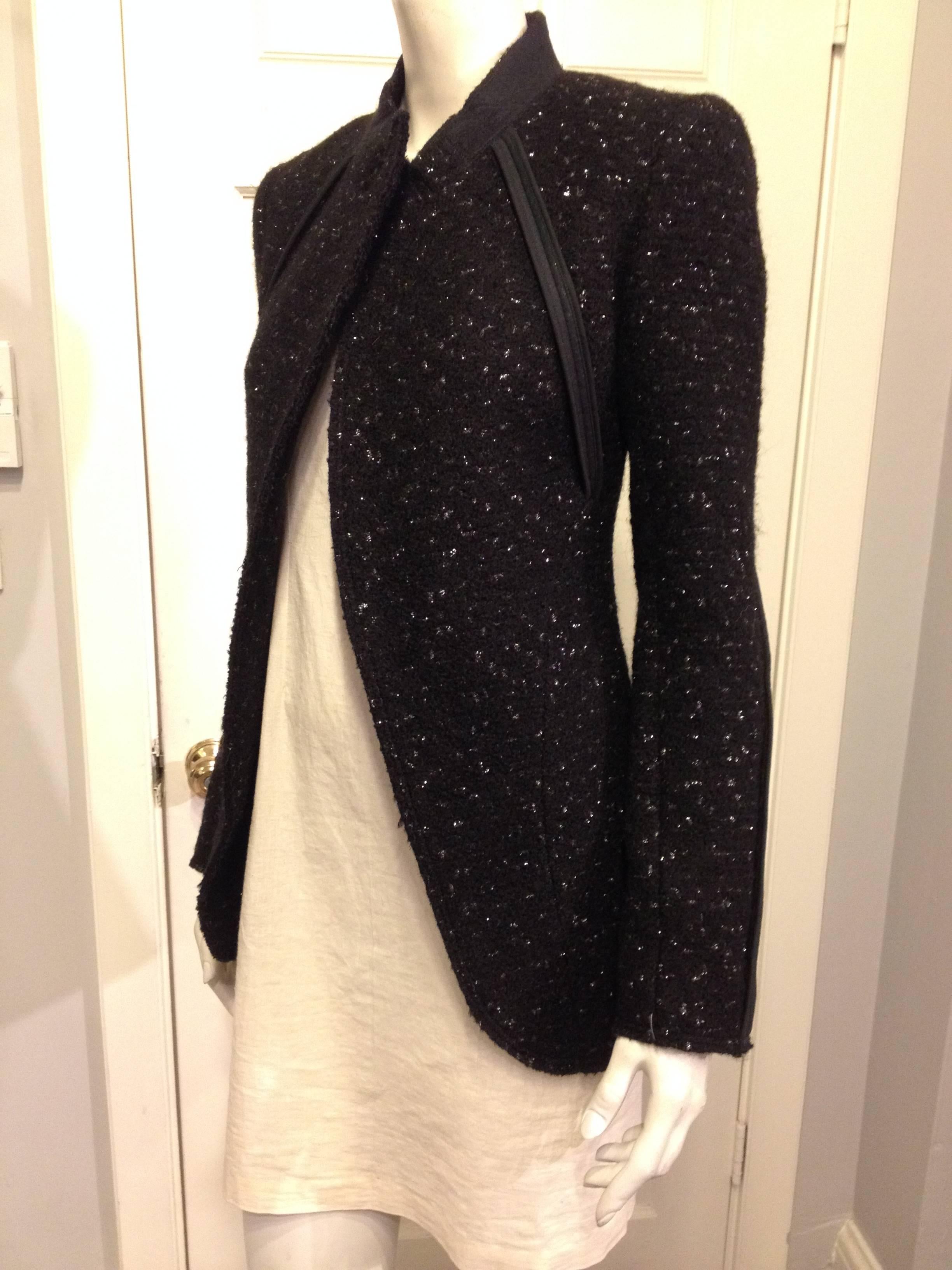 Cool and minimal but fun at the same time, this jacket is cut from ultra plush black material flecked with subtle silver spangles all over. The front is cut sharply with back-turned lapels and sweeping open lines, and each seam is finished but left