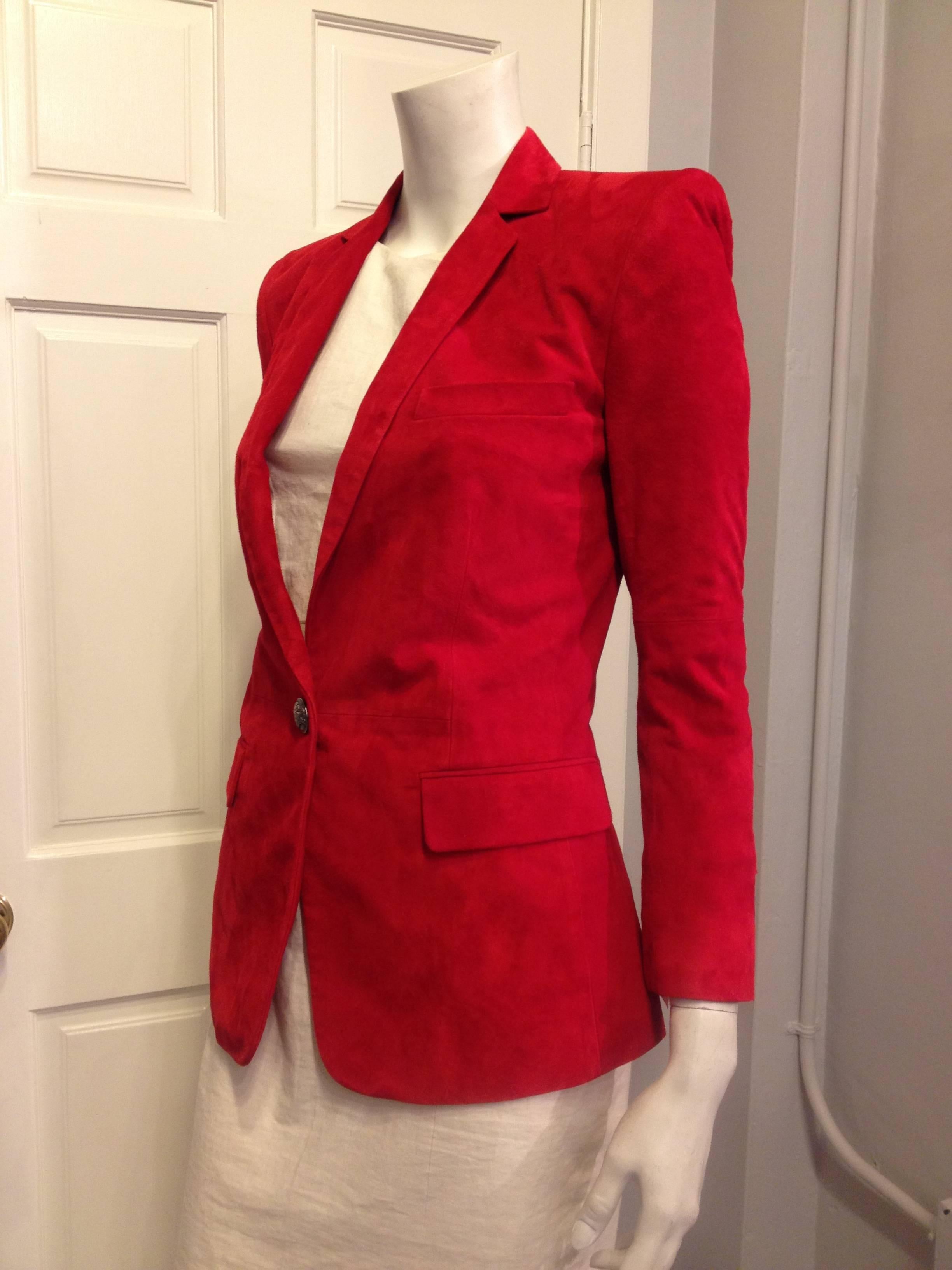 How iconic! A red suede blazer cut as sharply as this one is instantly so rock & roll, especially when it's made by Balmain. The shoulders are super-sculpted in the signature Balmain way, and the sleeves are slightly cropped for a shrunken fit. The