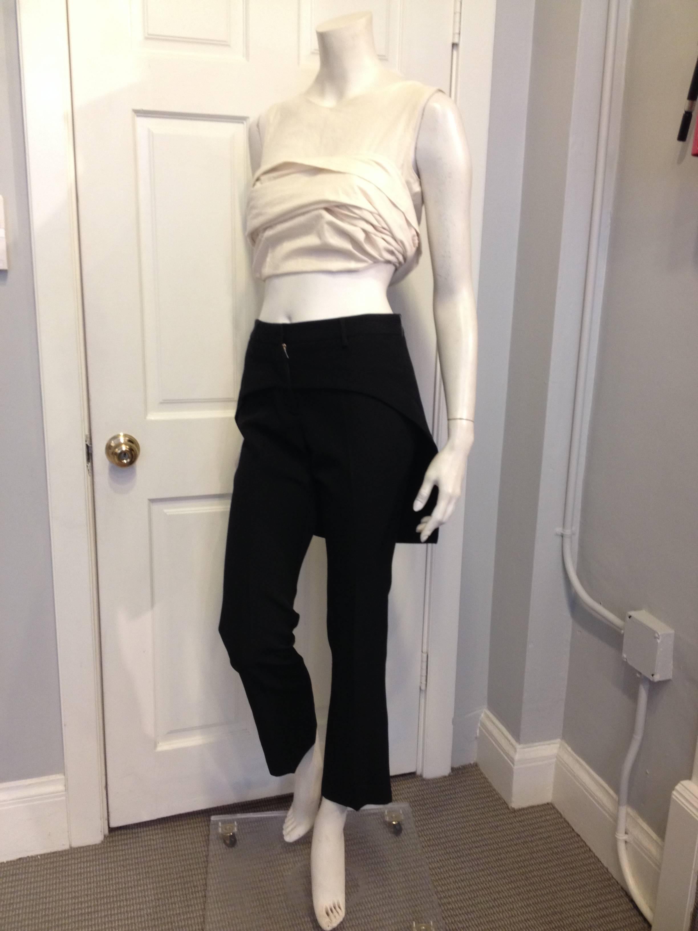 So cool! These Givenchy pants are cut slim and crisp with a very slight flare at the ankle, and are accessorized with a skirt-like band around the waist creating a tailcoat hemline. These are so unusual but at the same time so easy to wear, the hem