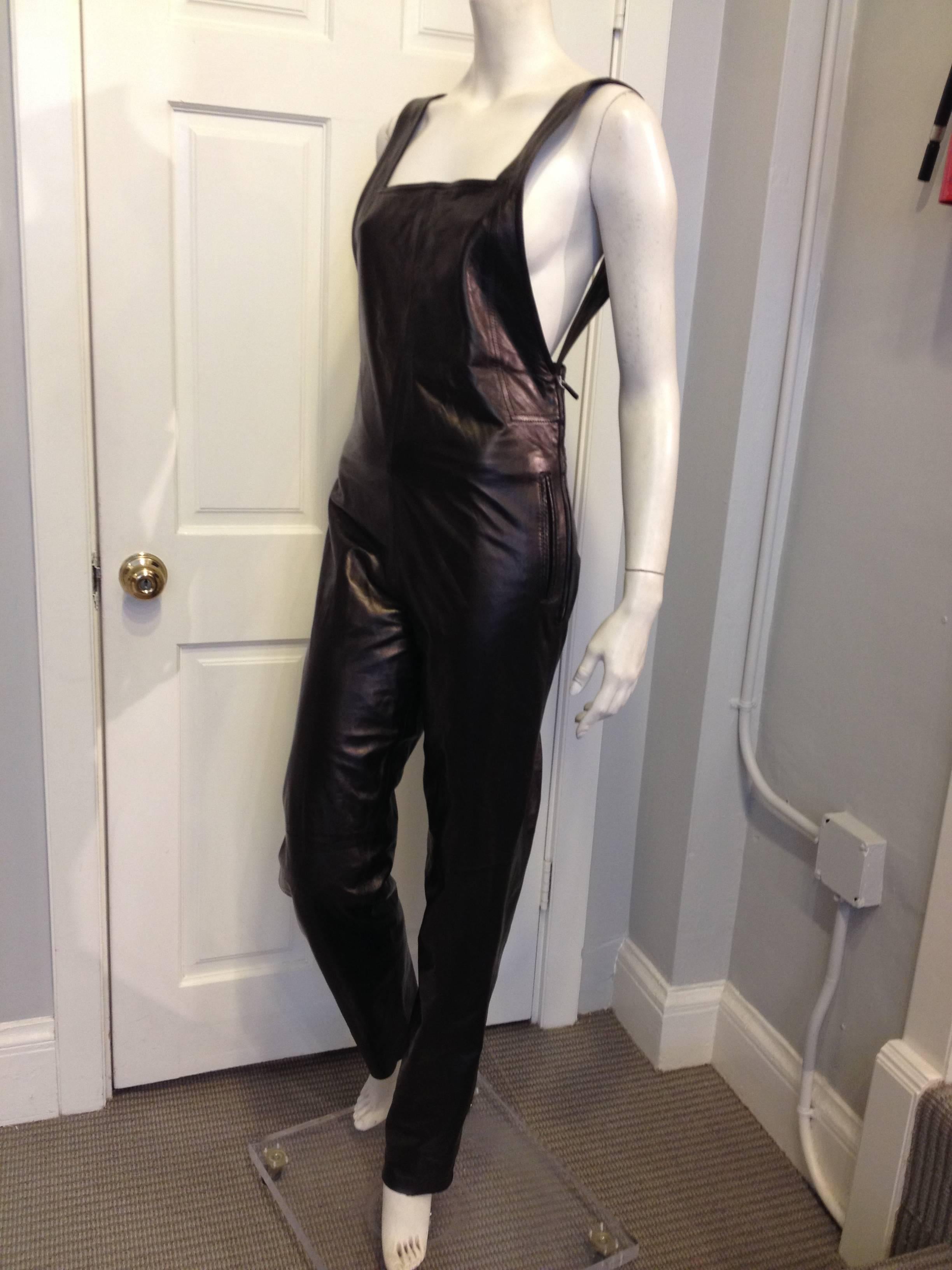 We're totally obsessed with these Yves Saint Laurent overalls! The utilitarian staple is completely made over in shiny super soft black leather, making them feel edgy, contemporary, and cool. These feature the classic bib and shoulder straps, which