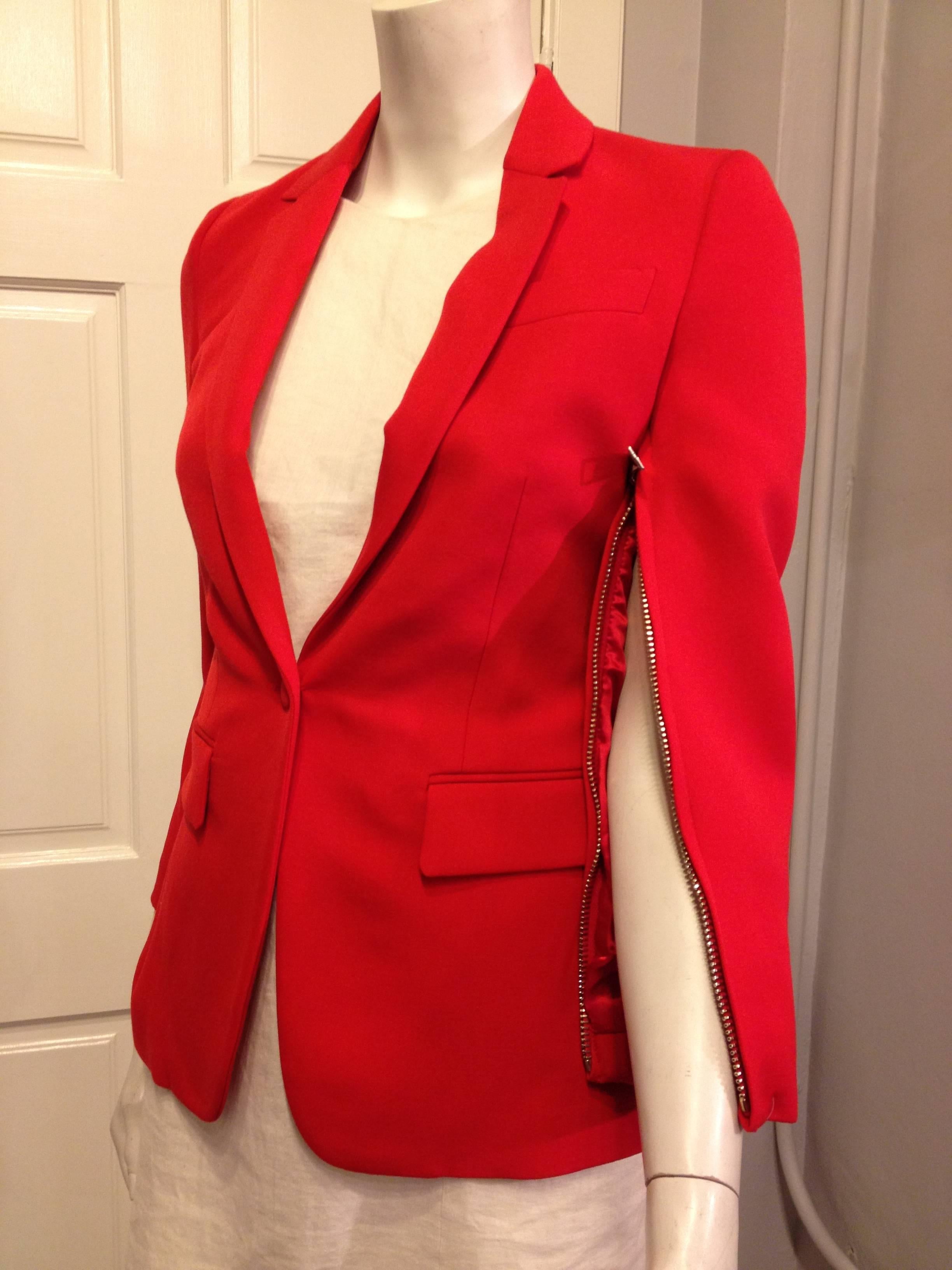 The absolutely gorgeous cut of this blazer is even more perfect in a vibrant, lush orangey red vermillion. The modern single button closure cinches the waist, while the slender lapels and hip pockets create an hourglass shape. The underside of each