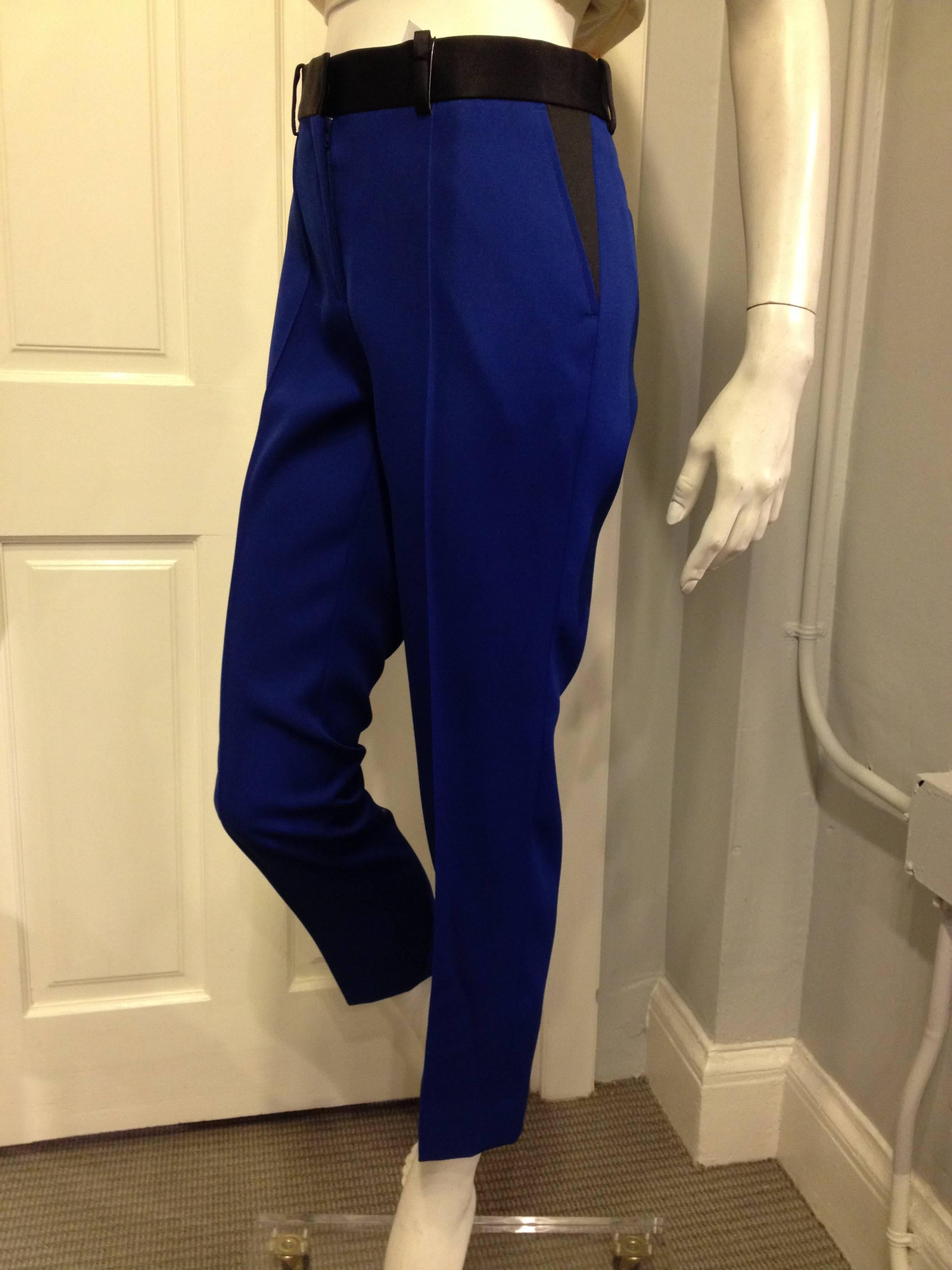 Beautiful and saturated bright blue makes this pair of Celine pants the perfect statement piece. The cut is crisp and very sharp, with a clean crease down the front of each leg and black satin trim along the waistband and at the jetted back pockets.