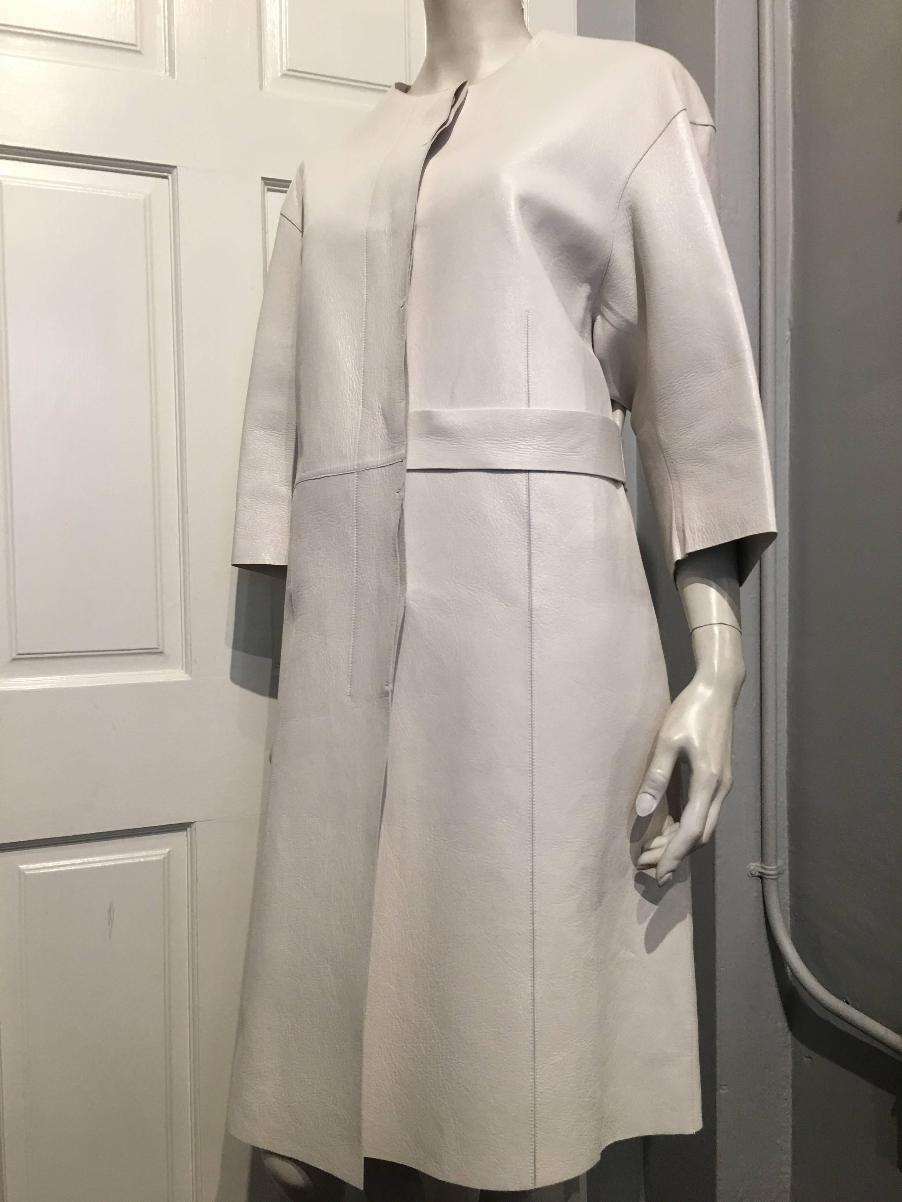Marni white leather coat with matching leather buttons and belt. The sleeves are 15 inches long. 