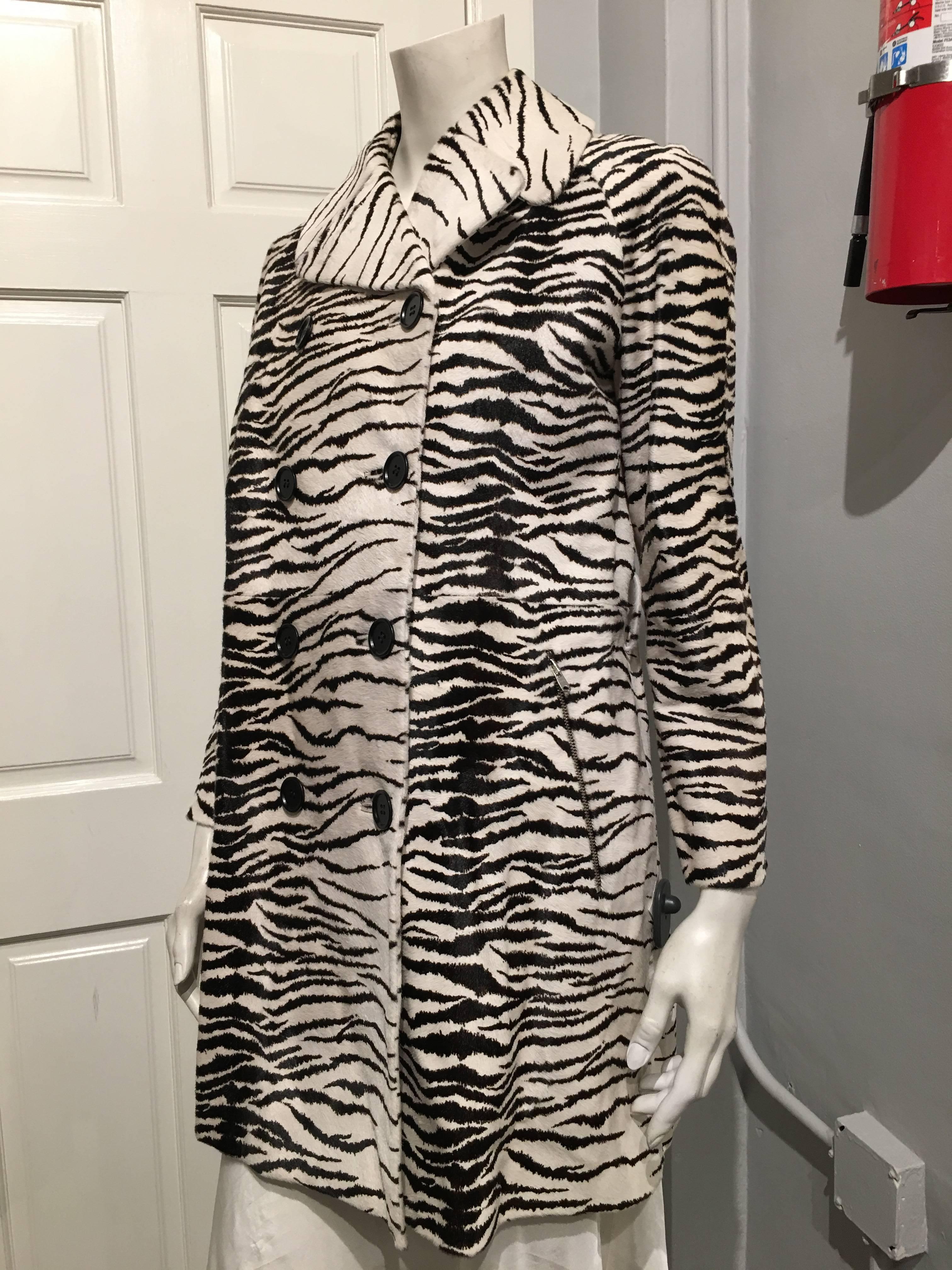 Flared, double breasted Alaia hair calf coat in a black and white zebra  pattern. The lining is black in a light water proof polyester material.

The coat is sold as is as the belt is missing.