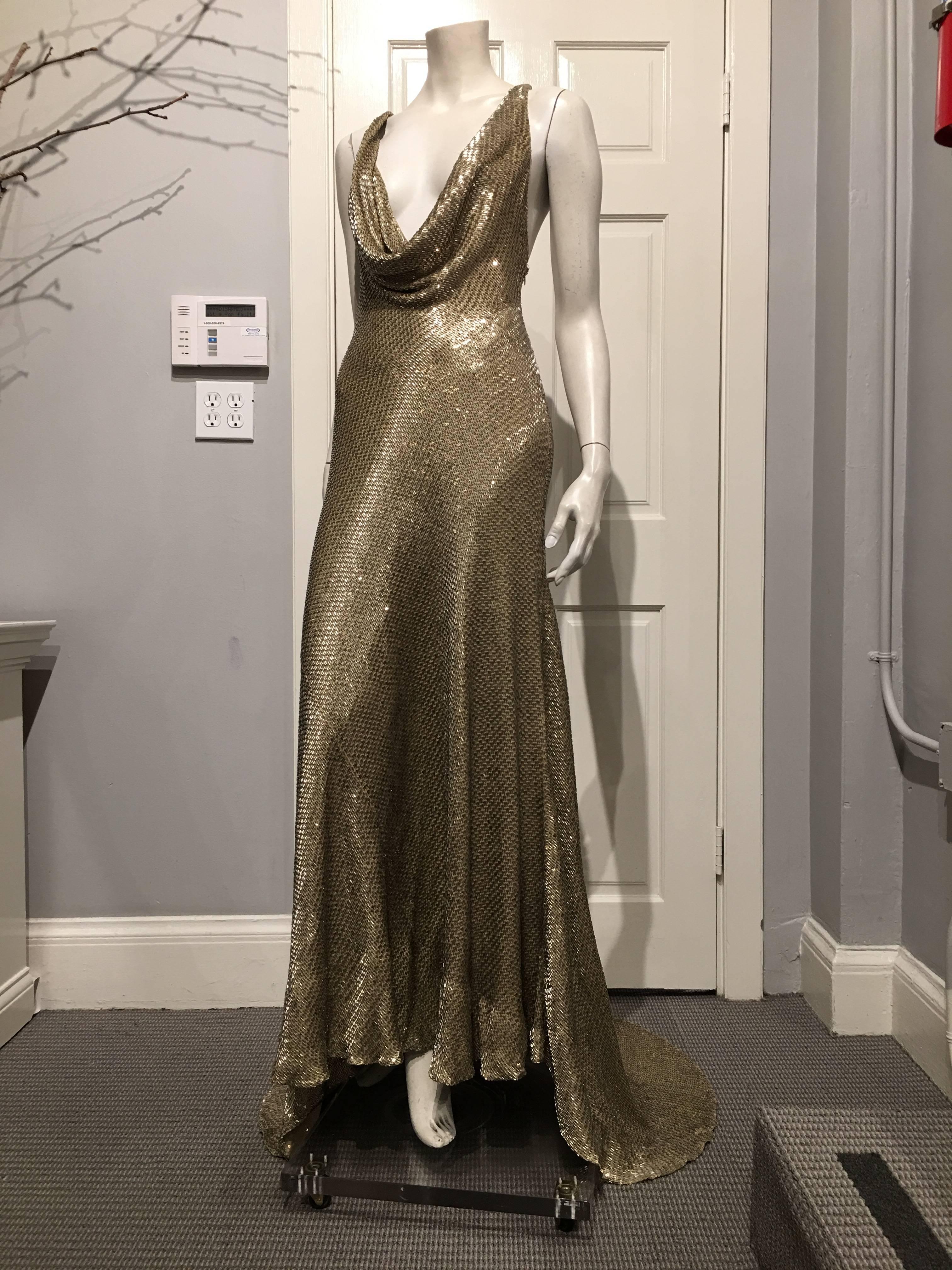 Ralph Lauren backless, sleeveless gown covered in gold beads and sequins.

The dress features a low cut draped neckline and train.