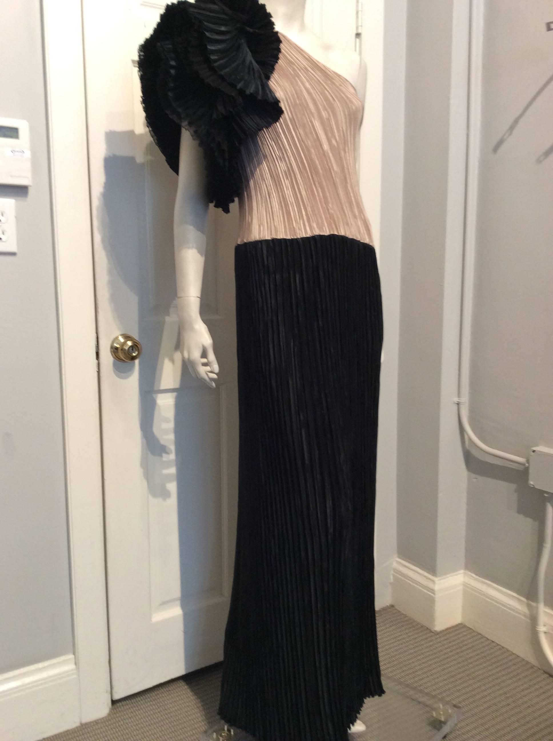Mary McFadden Black and Beige Pleated One-Shoulder Flounce Vintage Gown.  Muted gold bodice; Long black skirt; Black shoulder flounce.  Layered flounce and tight pleats.