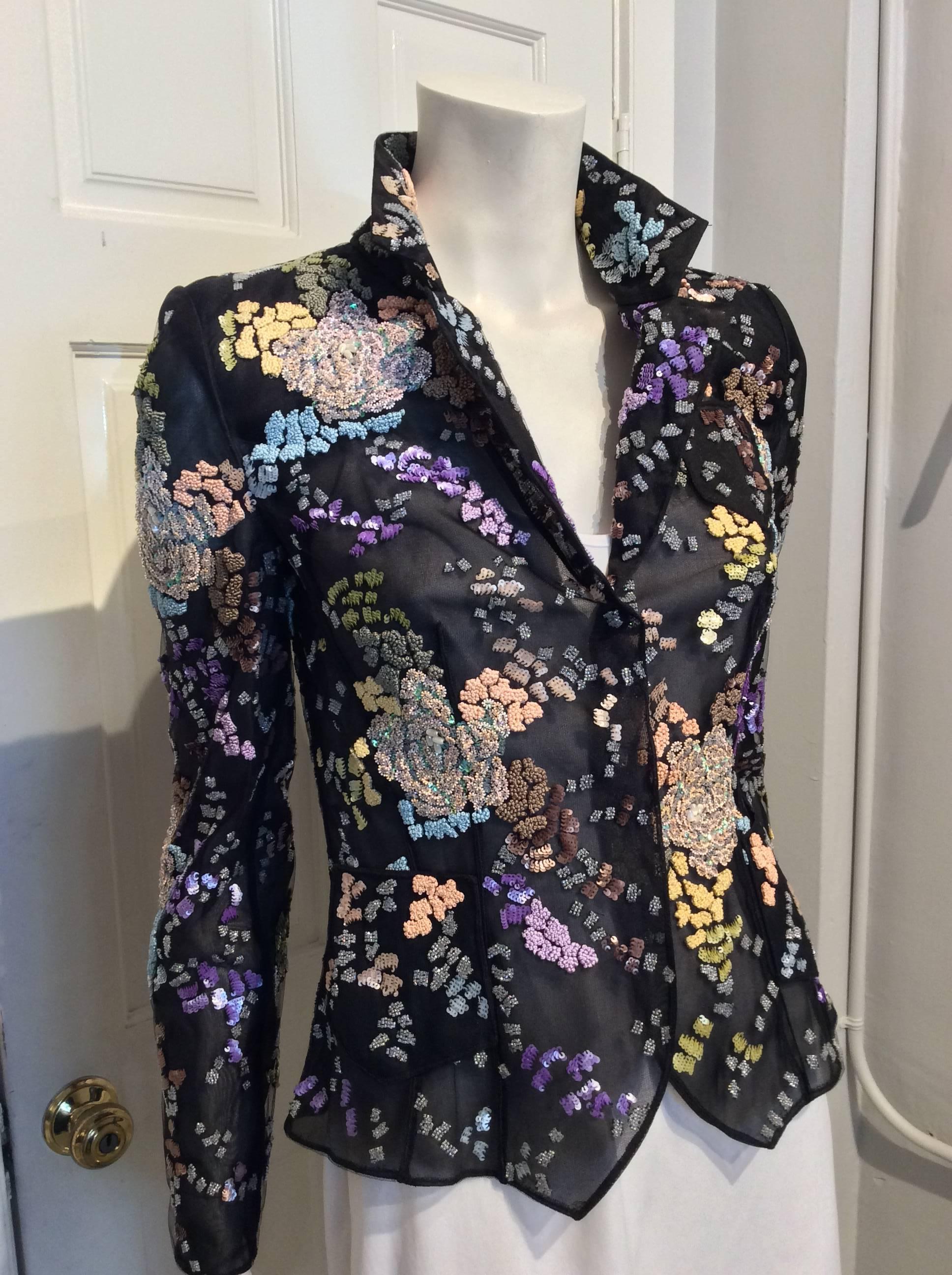 Giorgio Armani black mesh fitted blazer with multi-colored beads and sequins in a floral pattern. Beads and sequins are purple, blue, brown, yellow and pink; Embroidered rosettes; two small hip pockets, one small breast pocket; Closes in front with