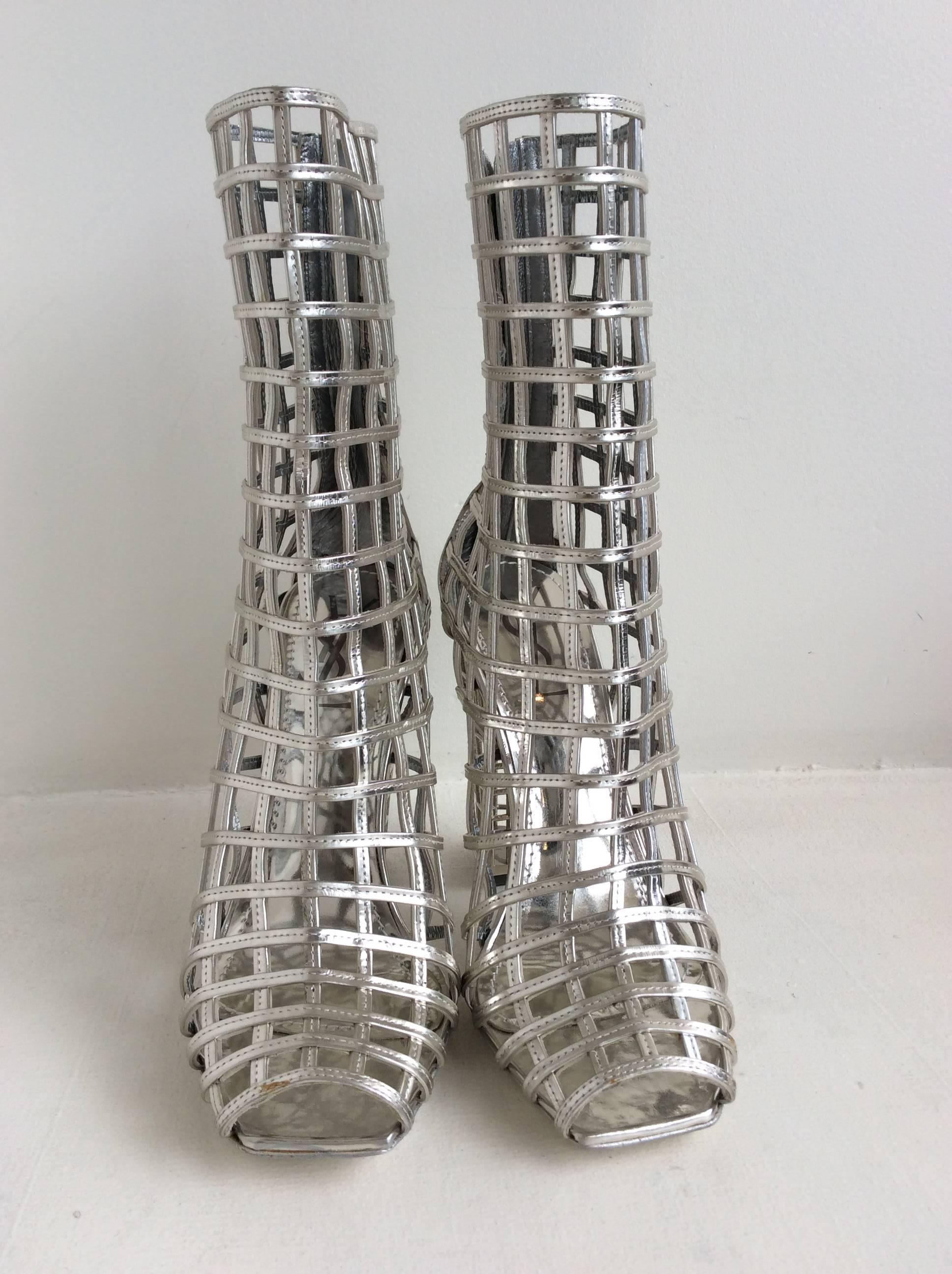 Silver cage peeptoe booties with 6 inch zipper closure at back and 4.5 inch heel. 