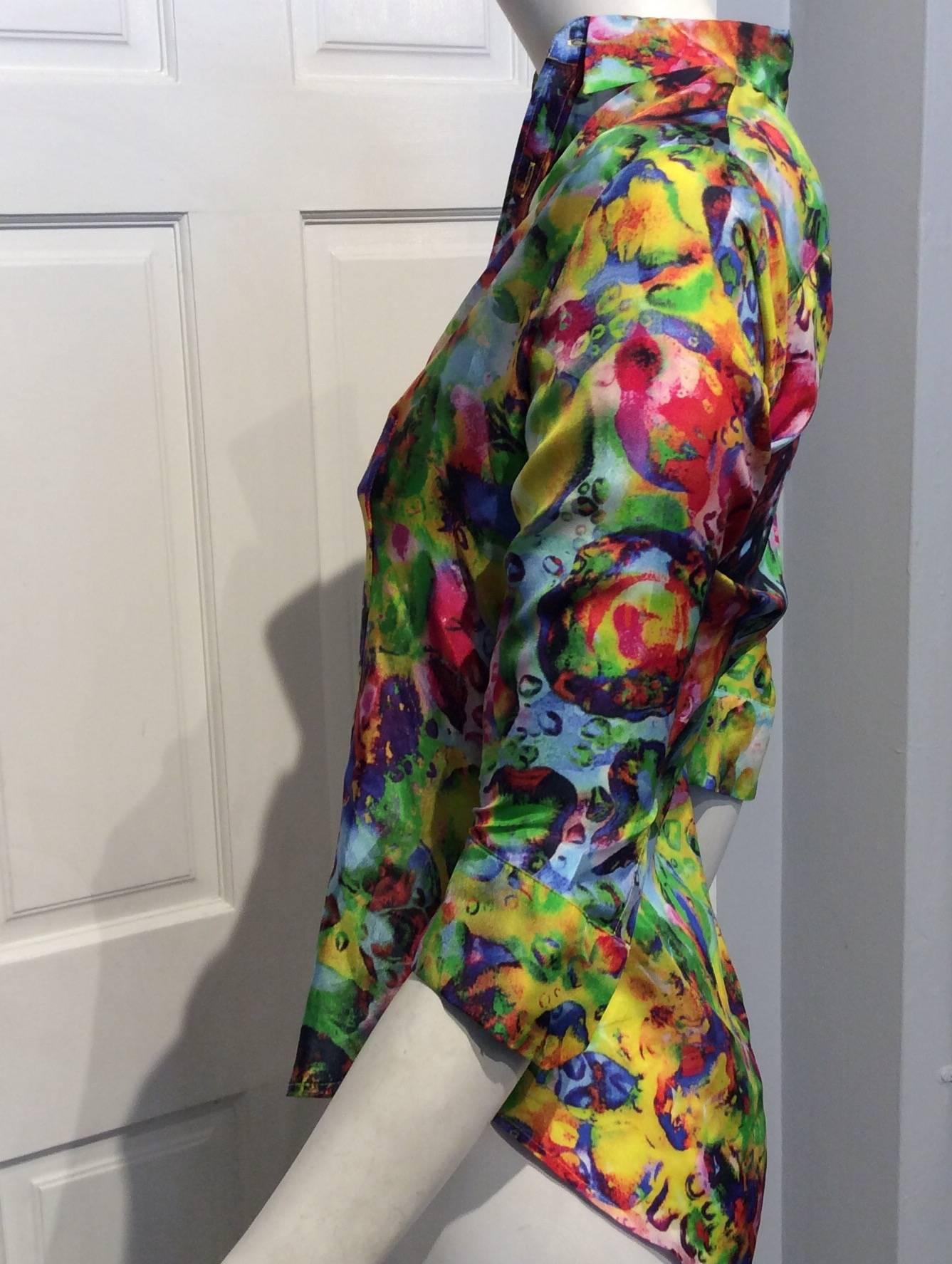 Eye catching silk shirt with a bright abstract print. The sleeves are 3/4. The shirt is new with the original tag of $1050.