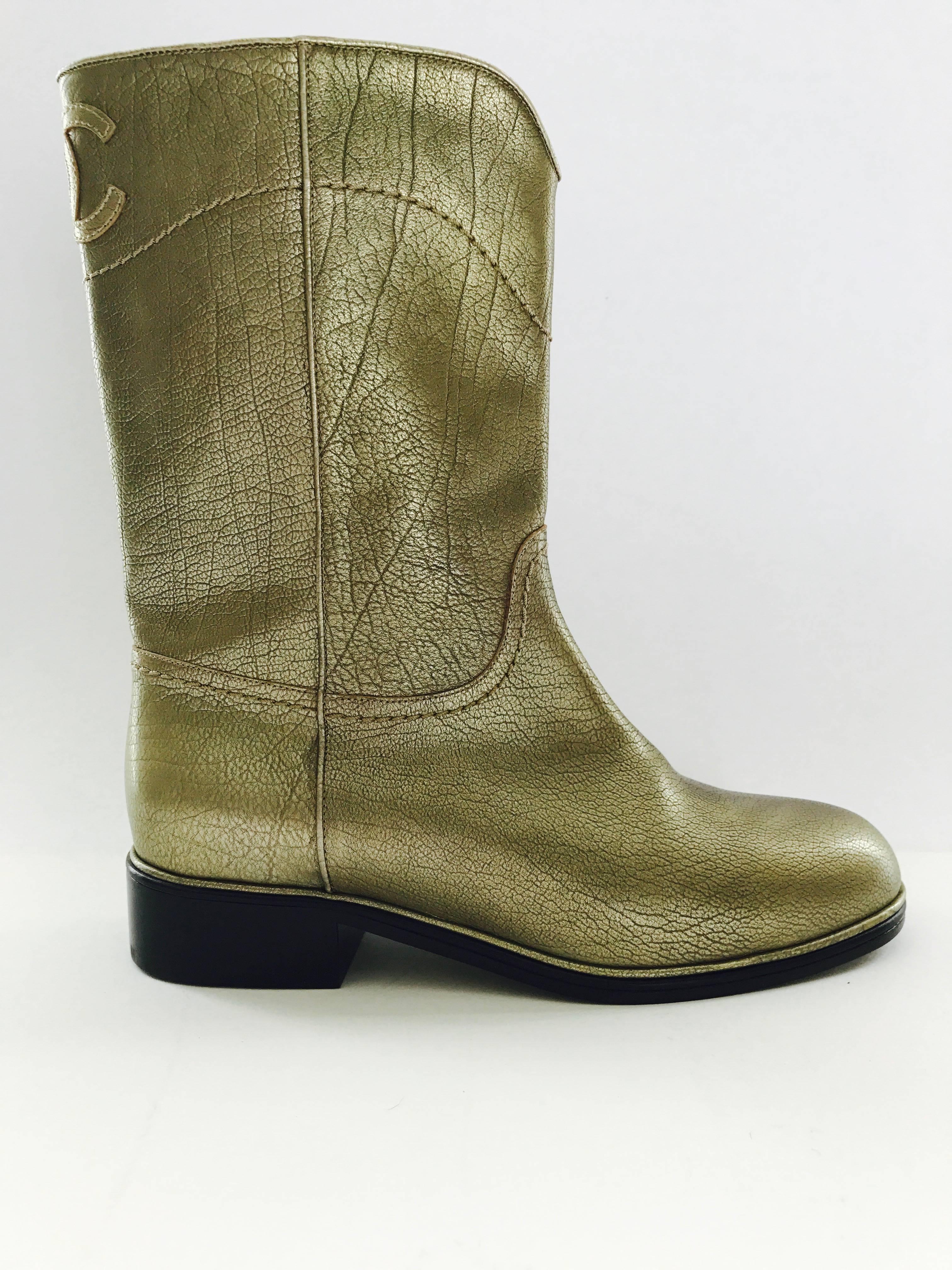 Cowboy inspired Chanel boots in muted gold leather in size 38 or US 8. The total height of the boot is 10 1/2 inches including the 1 inch heel. The width of the opening is 12 inches. 