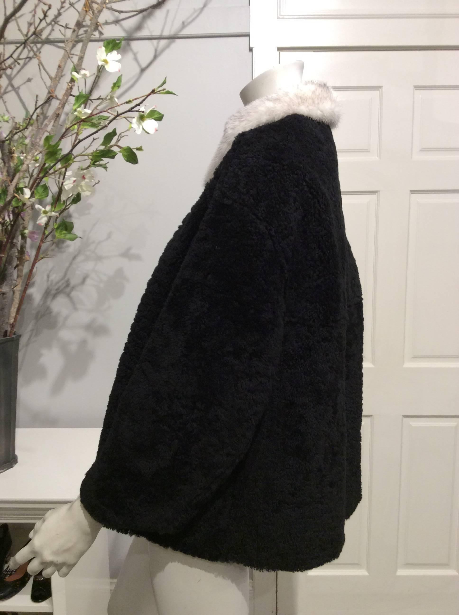 Black Prada shearling with the fur shown on the outside in size 42 US 6.
The cut is boxy and oversized leaving room for an extra layer. The white mink collar that features a narrow black stripe is attached with small black buttons and can be removed