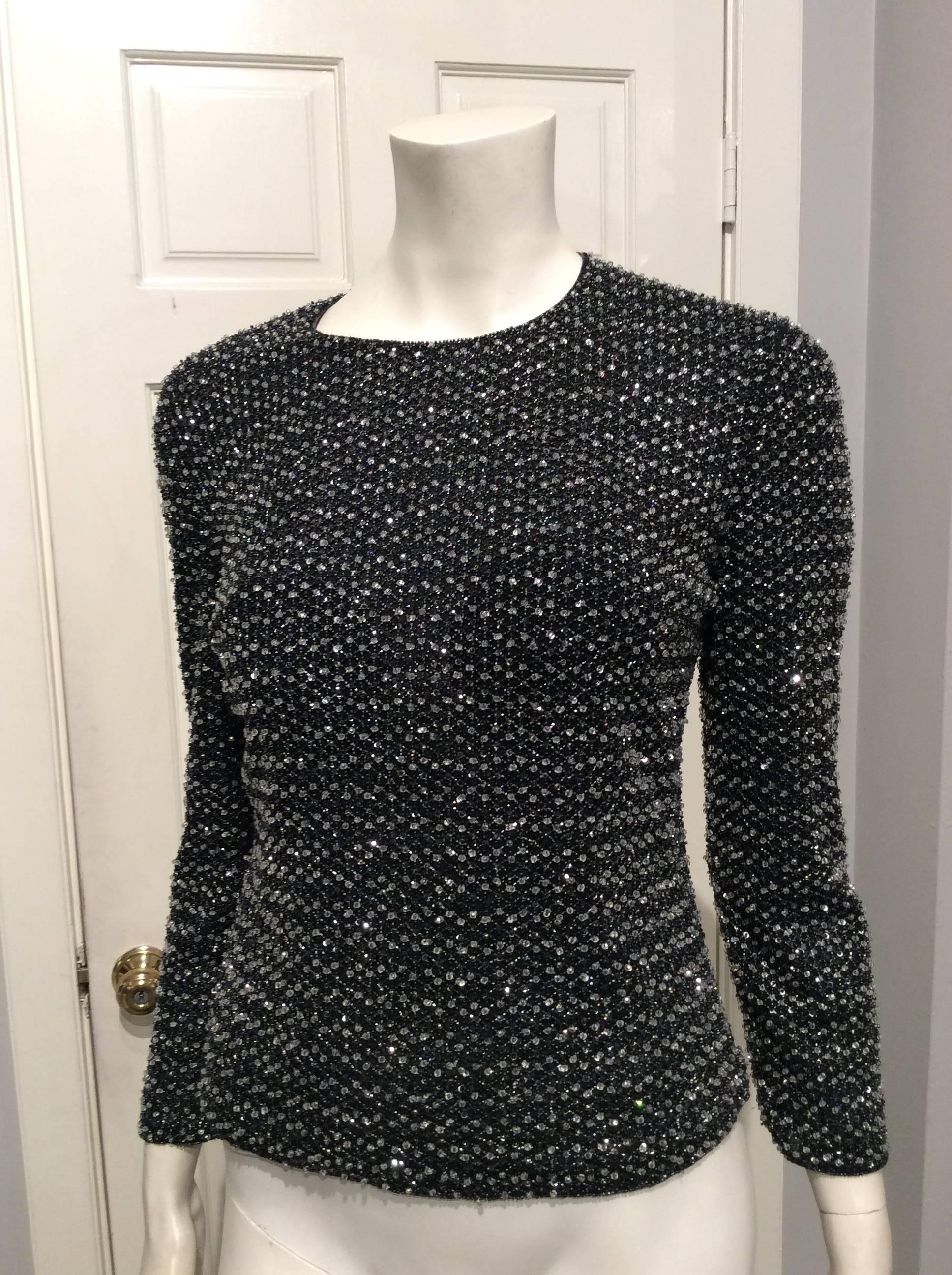 Giorgio Armani stunning long sleeve top in blue-black. Clear glass beads and smaller pewter ones form a honeycomb pattern that covers the front, the long sleeves and part of the sides. The back is open with corset like black sequin bands. 