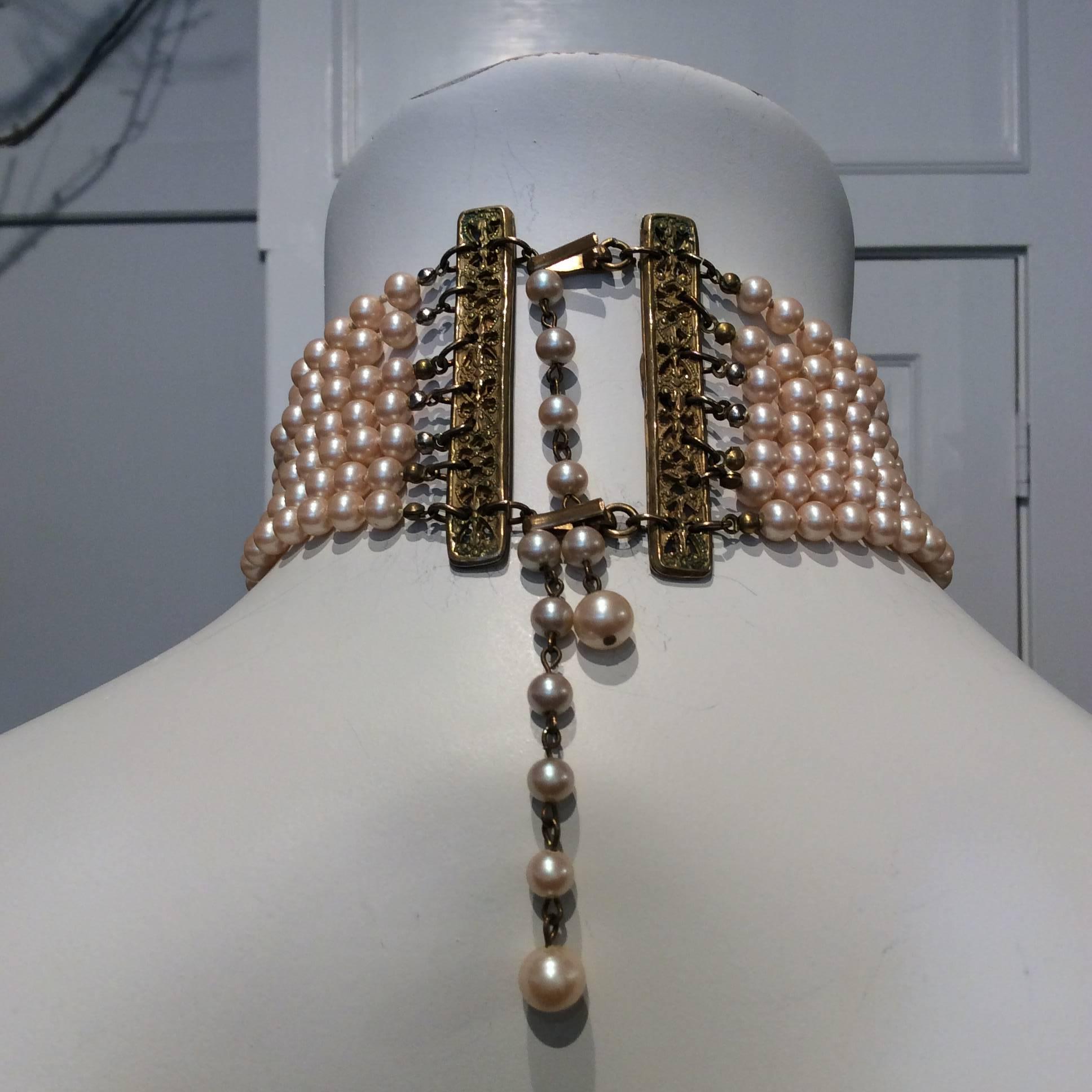 Beautiful Miriam Haskell seven strands pearl choker made exclusively for Ralph Lauren. It closes with two hooks and it can go from 12 1/2in to 14 1/2in. 
 
Please note that some of the clamshell tips have tarnished differently as shown on image 3