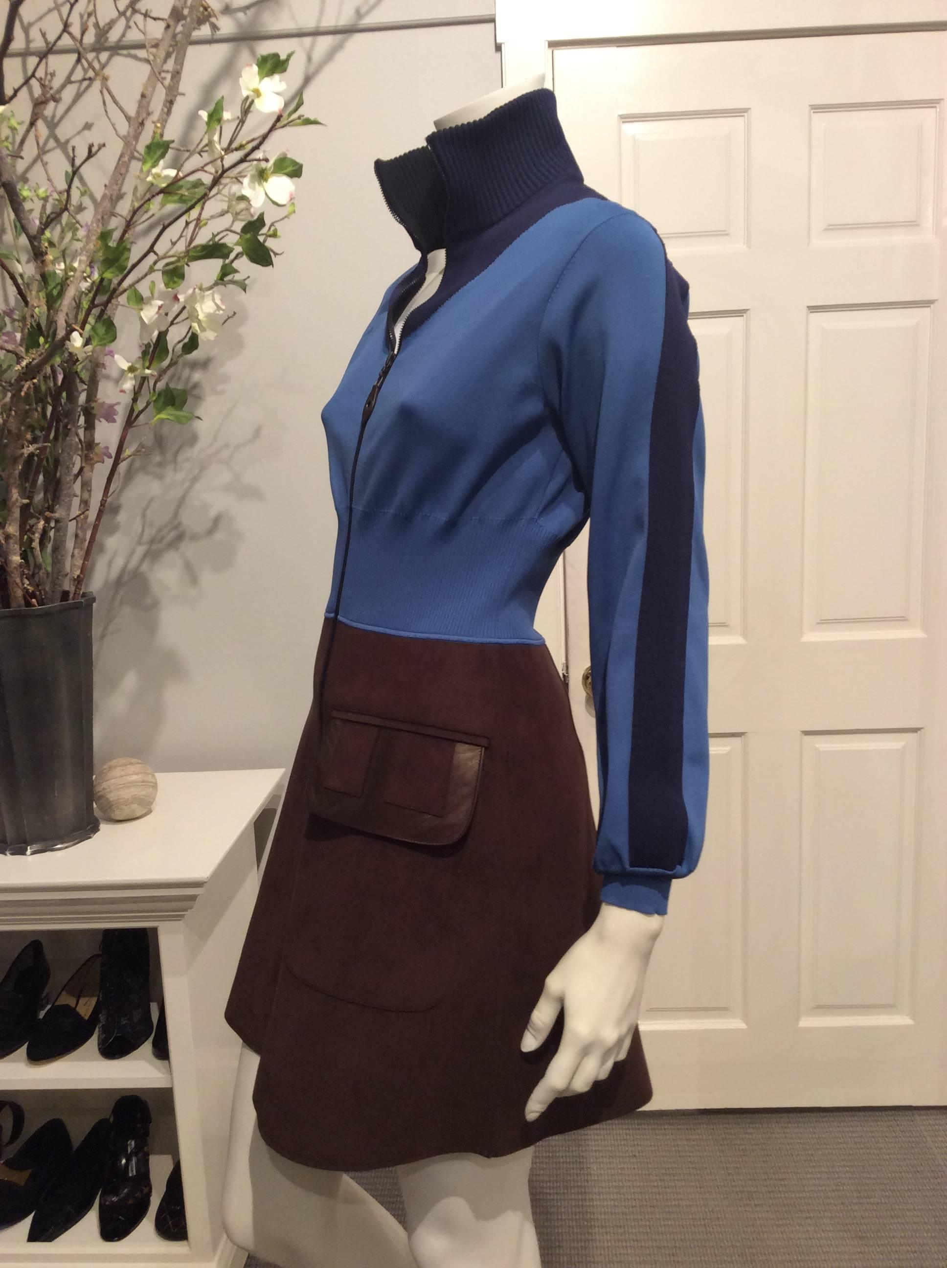 Sporty Louis Vuitton coatdress with a mock blouson upper part in teal and navy and a brown flared ultra suede skirt with an oversized flap pocket trimmed in leather.  It has a long zipper that goes almost the whole length of the dress and allows it