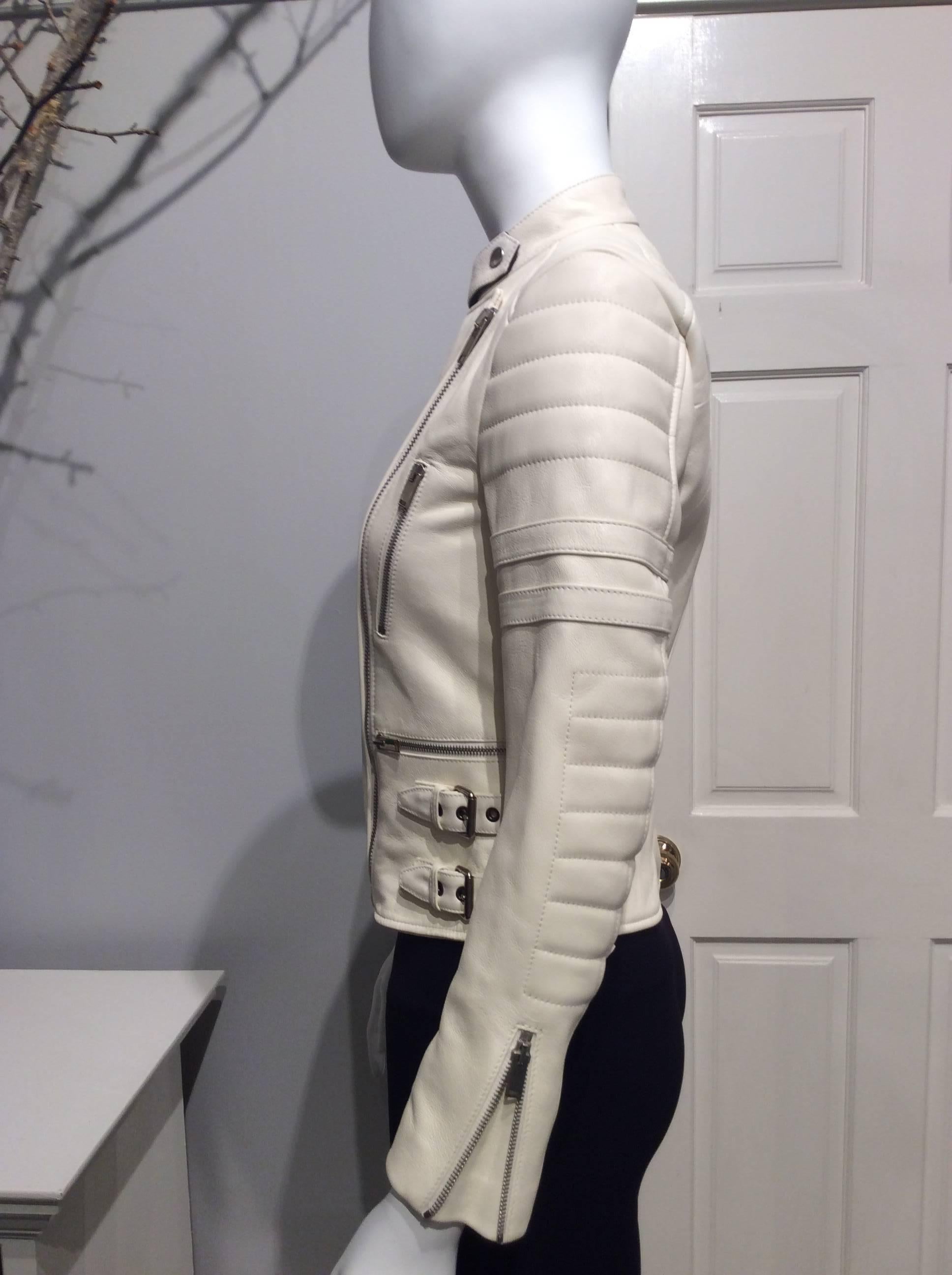 Striking Céline motorcycle jacket from the 2014 collection designed by Phoebe Philo. 
This soft white lambs leather jacket has as a contrast a wonderful vibrant red lining. To protect from wear the collar is lined in black baby corduroy. 
The