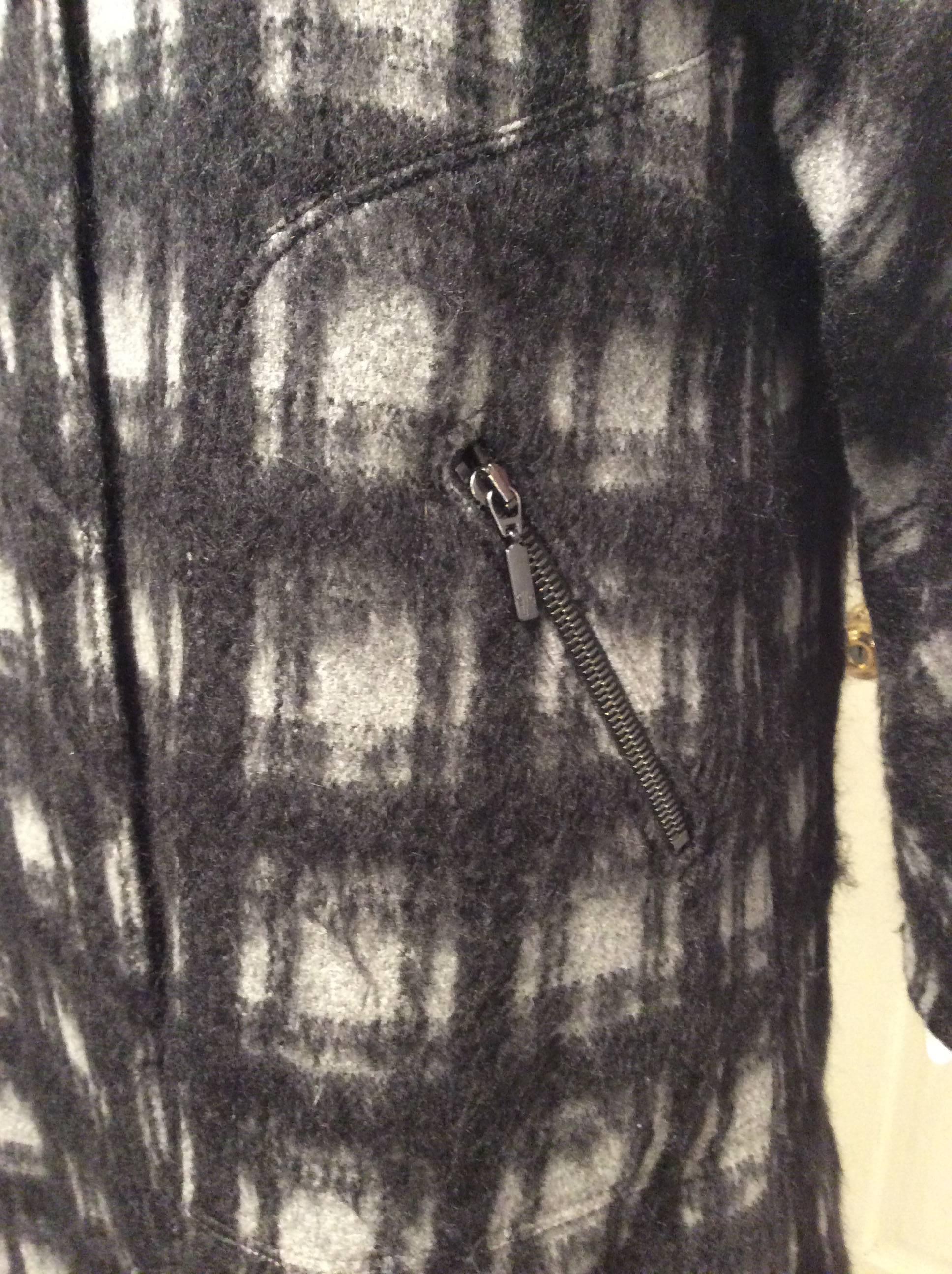 Mohair coat in grey and black plaid with black quilted removable down lining.The lining is attached with nineteen  1/2in buttons. The top layer is unlined and has french seams. It closes with a 30in zipper and six big gunmetal colored snaps. It has