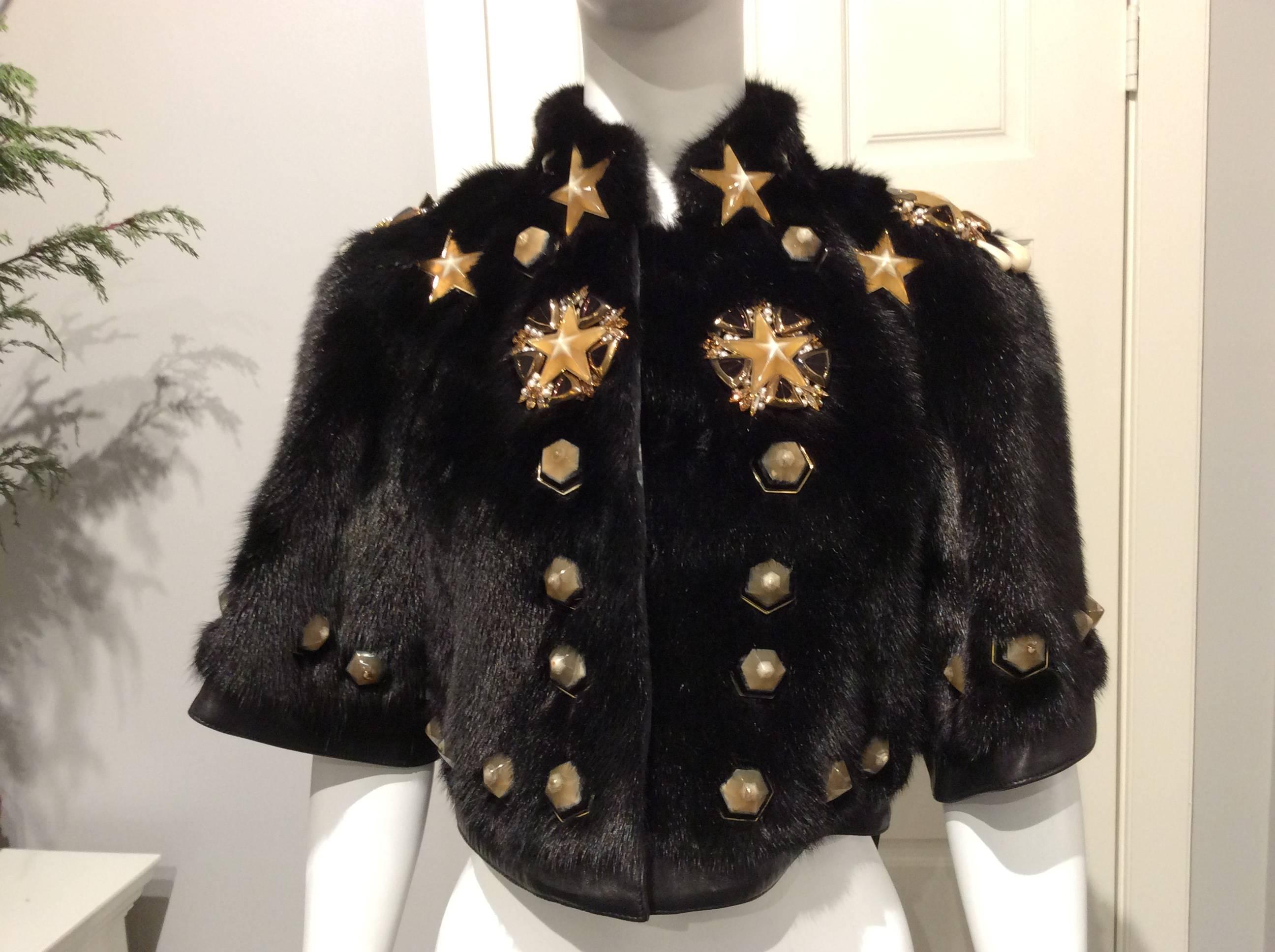 Stunning black mink tailcoat with gold framed honey colored stars embellishments. In addition it features pearls, beads, rhinestones and stone like studs in shades that go from amber and ivory to black.
The body and the elbow length kimono sleeves