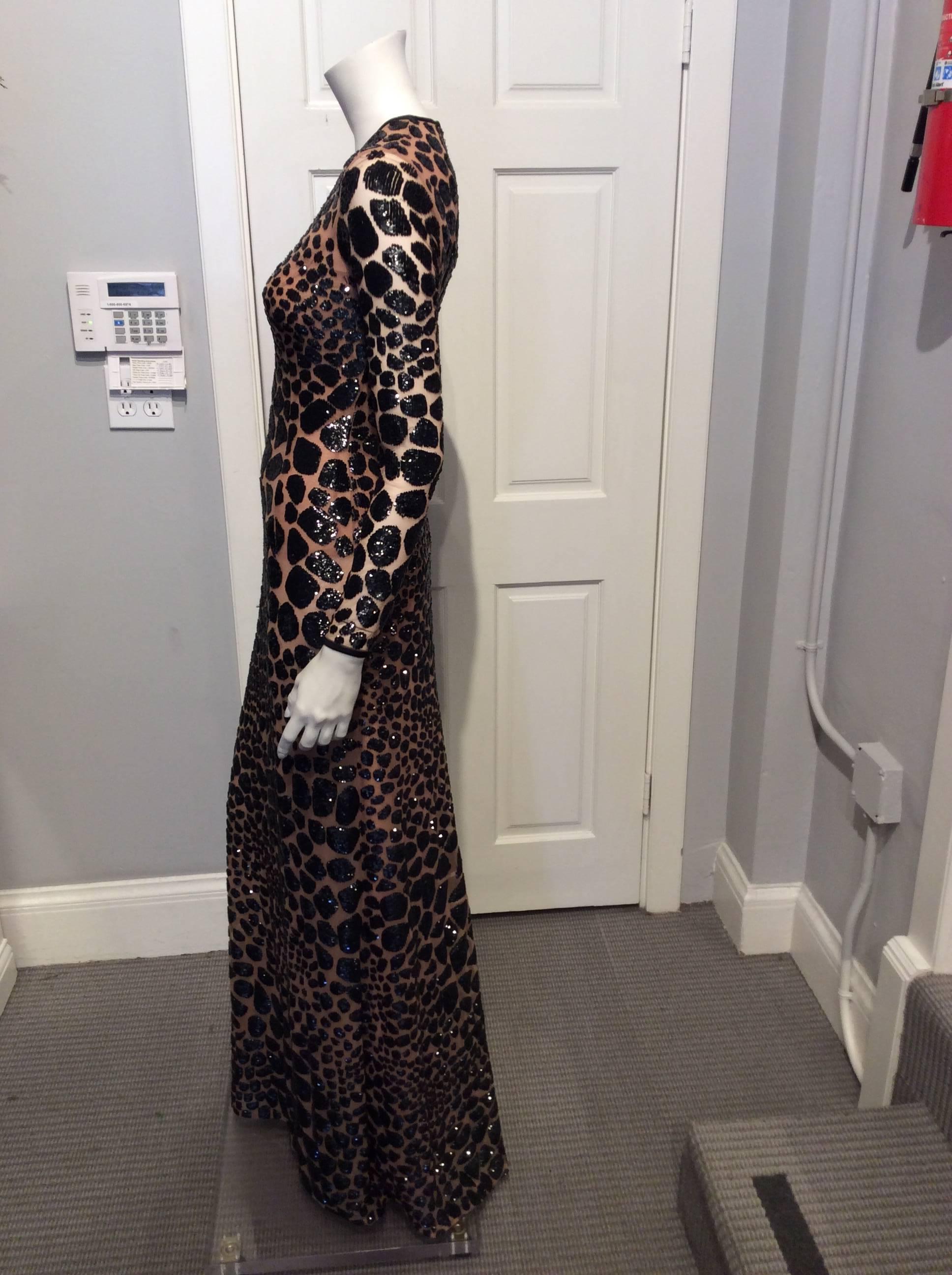 Michael Kors long sleeve body con gown with leopard spots embroidery in black sequins. The dress comes with a built in mesh bodysuit.