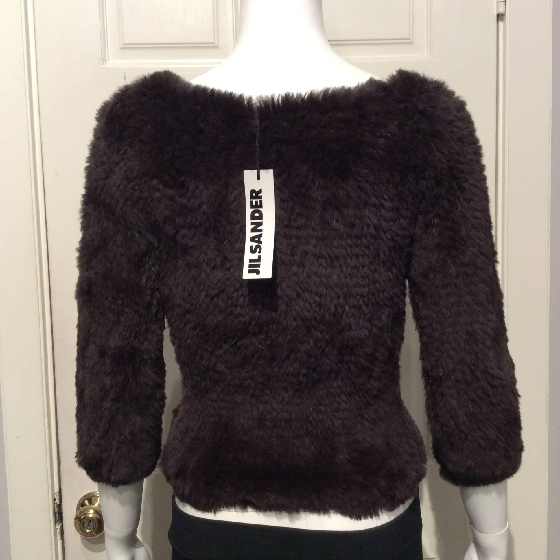 Jill Sander softest sweater in chocolate brown rabbit fur with a slight boat neck and 3/4 length sleeves.
This item is brand new with tags.