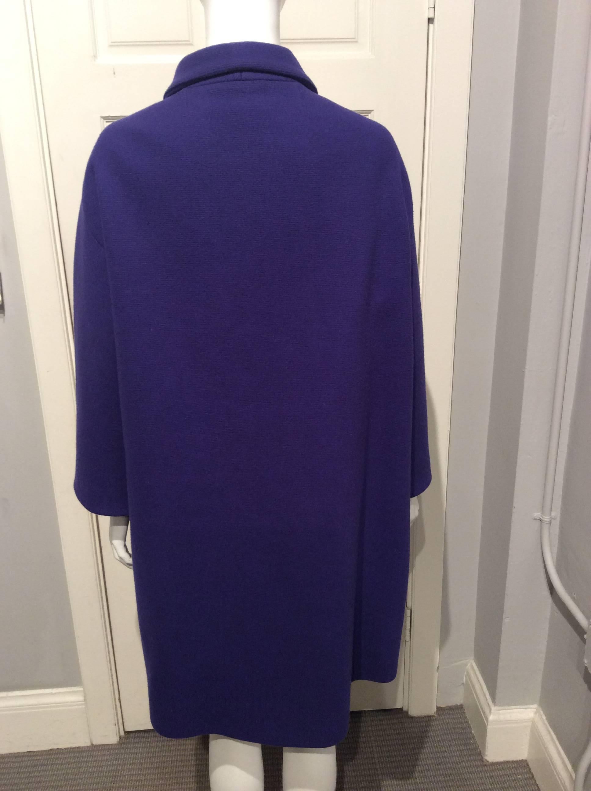 Balenciaga purple retro looking oversized wool coat with kimono sleeves. It has two slanted pockets in the front. The lining is silk.
