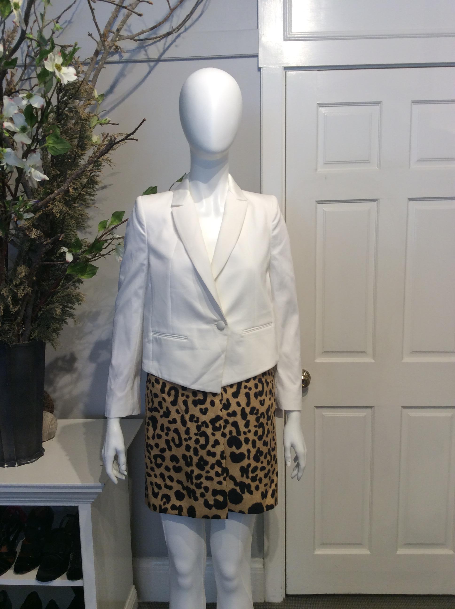 Givenchy white and leopard print knee-length cotton coat. White structured top with paneled vent at back with leopard print skirting at bottom. Single button closer at front. Single button at each cuff. 

Sizing: Fr36, US 4

Fabric content: 100%