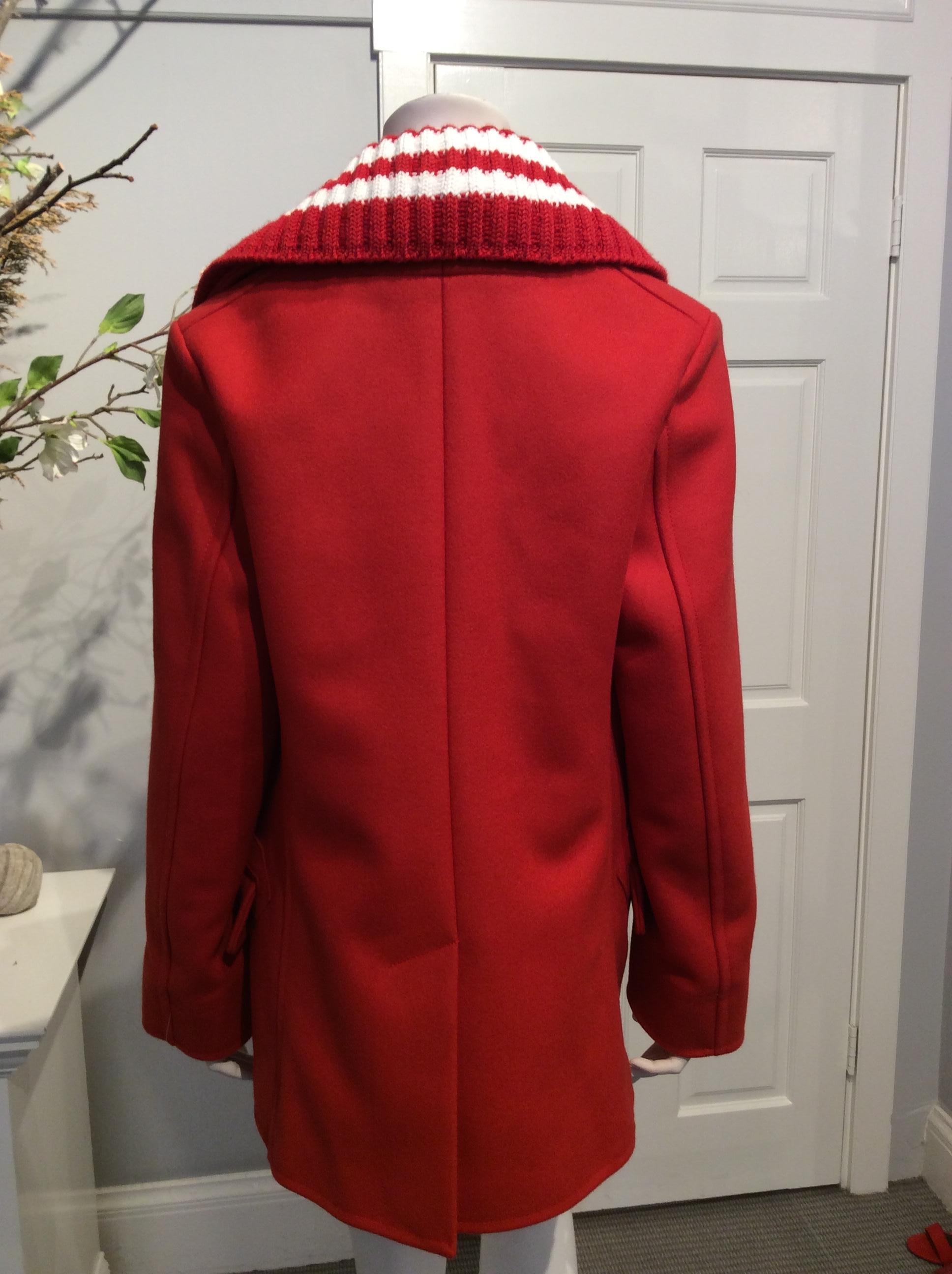 Givenchy Fall/Winter 2017 double breasted red wool pea coat with detachable striped knit collar. Four exterior pockets and two interior pockets.
