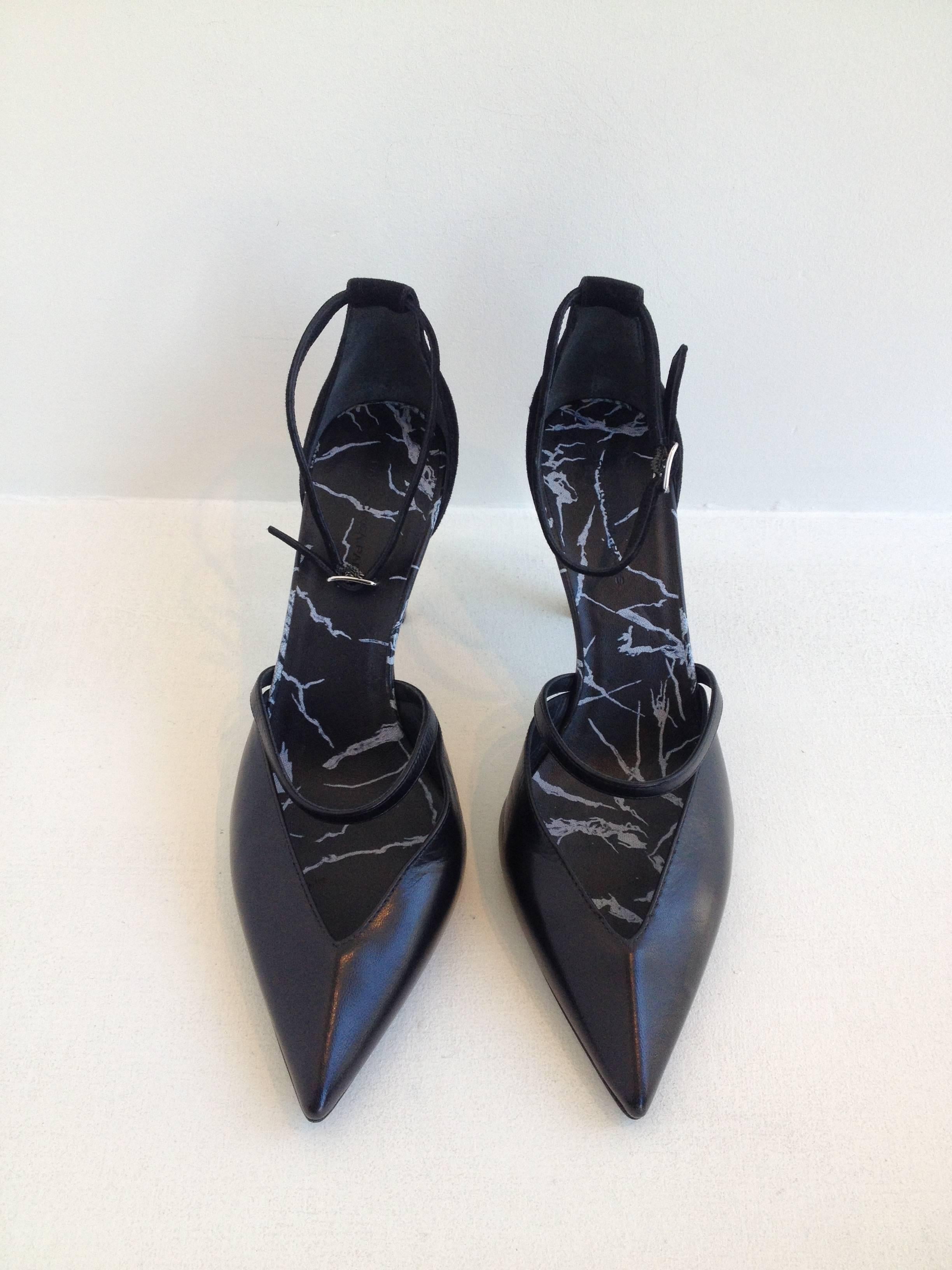 Sleek, edgy, and ultra-modern, these heels are absolutely perfect. The pointed toe and the strap that wraps around the foot just above the toe are made of gorgeous black leather, while the 3.5 inch heel and ankle strap are cut from super soft black
