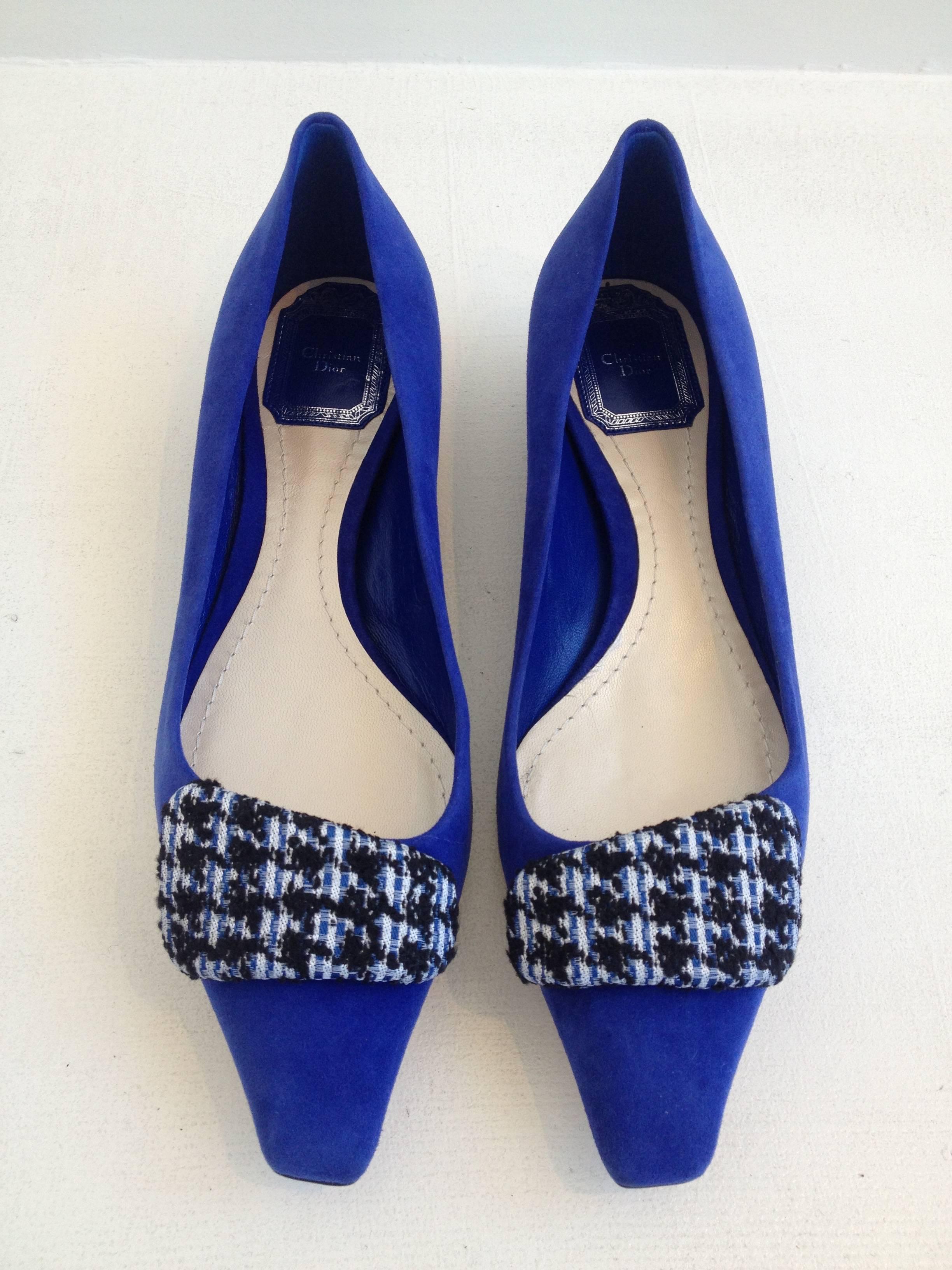 Channel the 1960s with these fabulous flats. Beautiful royal blue suede is embellished with a mod houndstooth tweed-covered shape on the toe, which is squared off for a feminine and retro look. The angled .75 inch heel adds a very Dior look,