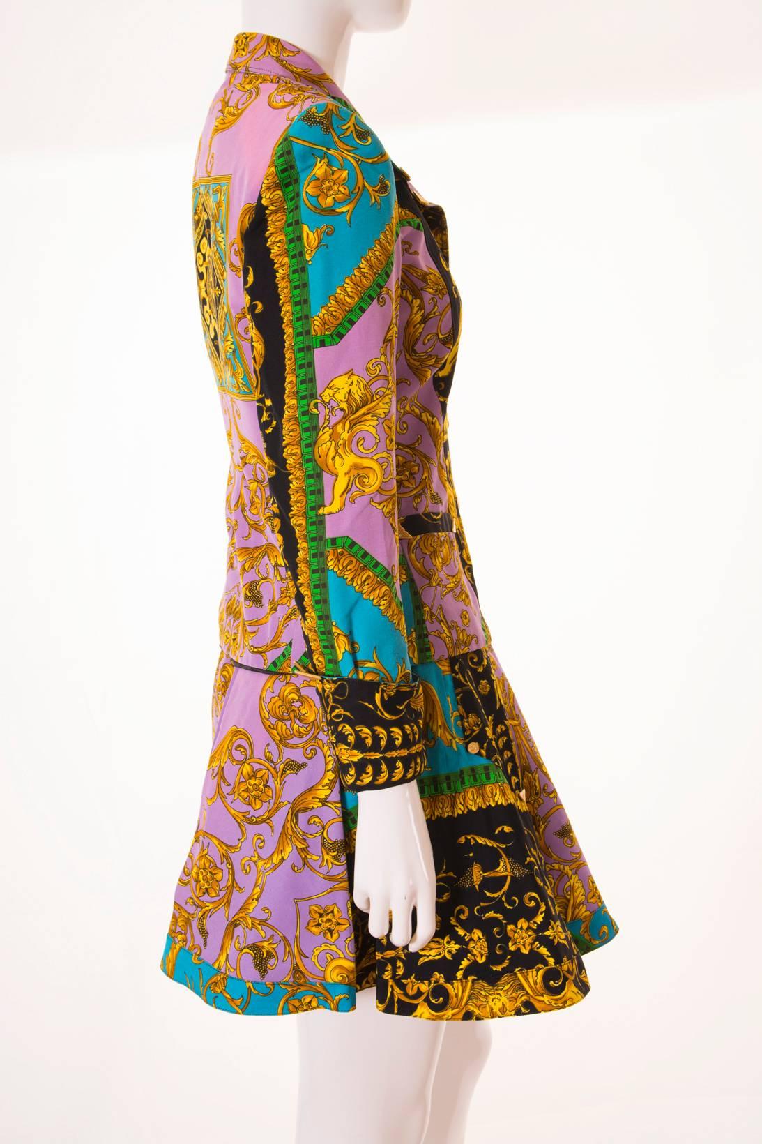 The print on this skirt suit by Versus Versace is truly to die for! This suit has the most intricate Baroque inspired print in lavender, gold and bold turquoise.  There are lions at the front of the jacket, and a lion's head at the back.  Both the