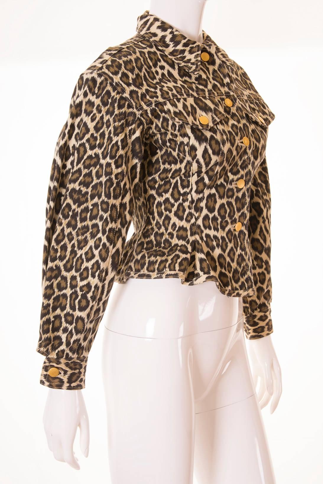 Denim jacket by Junior Gaultier. Circa 90s. Animal print. The fabric is quite sturdy so it keeps its shape. Exaggerated silhouette. Nips in at the waist and then flares out again. Sleeves which puff out. Gold junior Gaultier signature buttons. Two