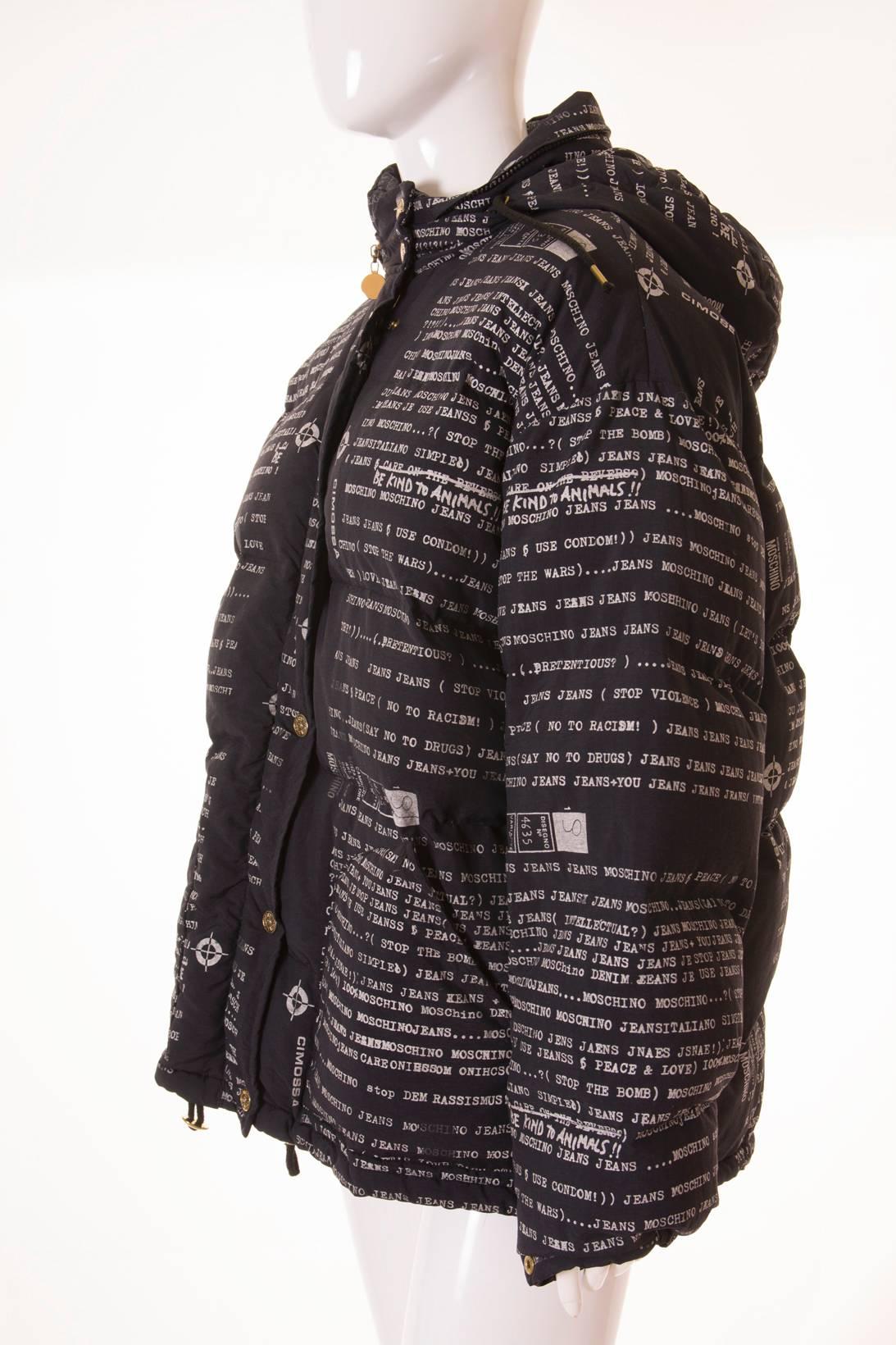 This puffer jacket by Moschino Jeans features an all over typewriter print. The text on the jacket features the word “Moschino Jeans” repeated over and over along with phrases such as “Be Kind to Animals”, “No to Racism”, “Stop Violence”, “Say No to