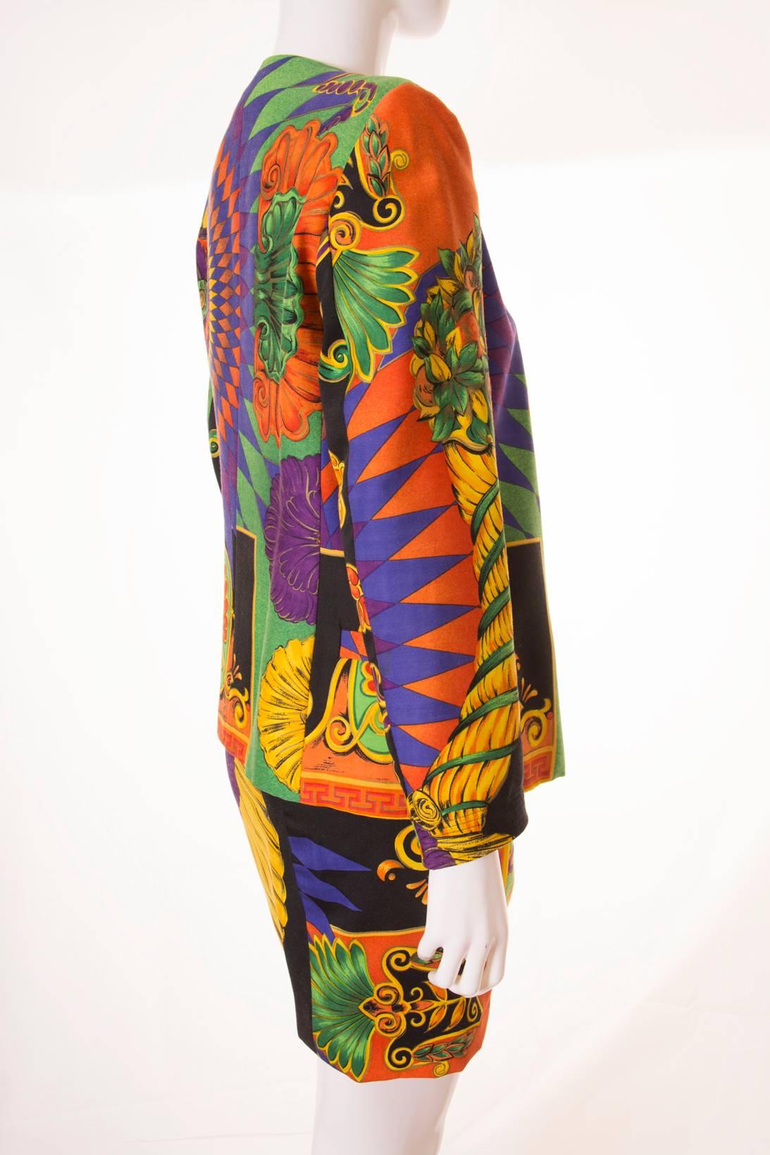 This suit is a beautiful example of Gianni Versace's skirt. The print is vibrant and incredible with big seashells and baroque flourishes.  Bold colourway in rich hues of purple, orange, gold and emerald green. Quality beyond compare. The one thing