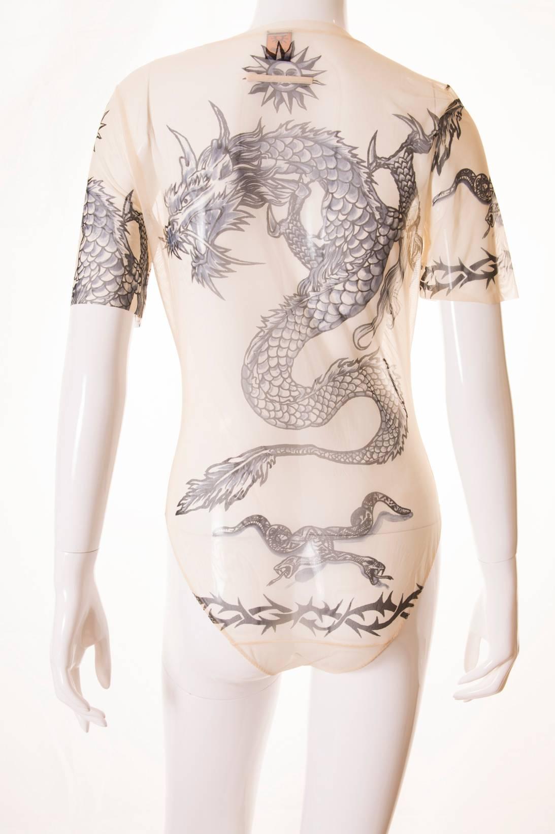 Contemporary issues. This 1994/1995 bodysuit by Jean Paul Gaultier Soleil transmits a pertinent social message; wrap it up! This bodysuit is made from sheer, skin coloured fabric so that it gives the illusion the wearer is tattooed. The tattoo