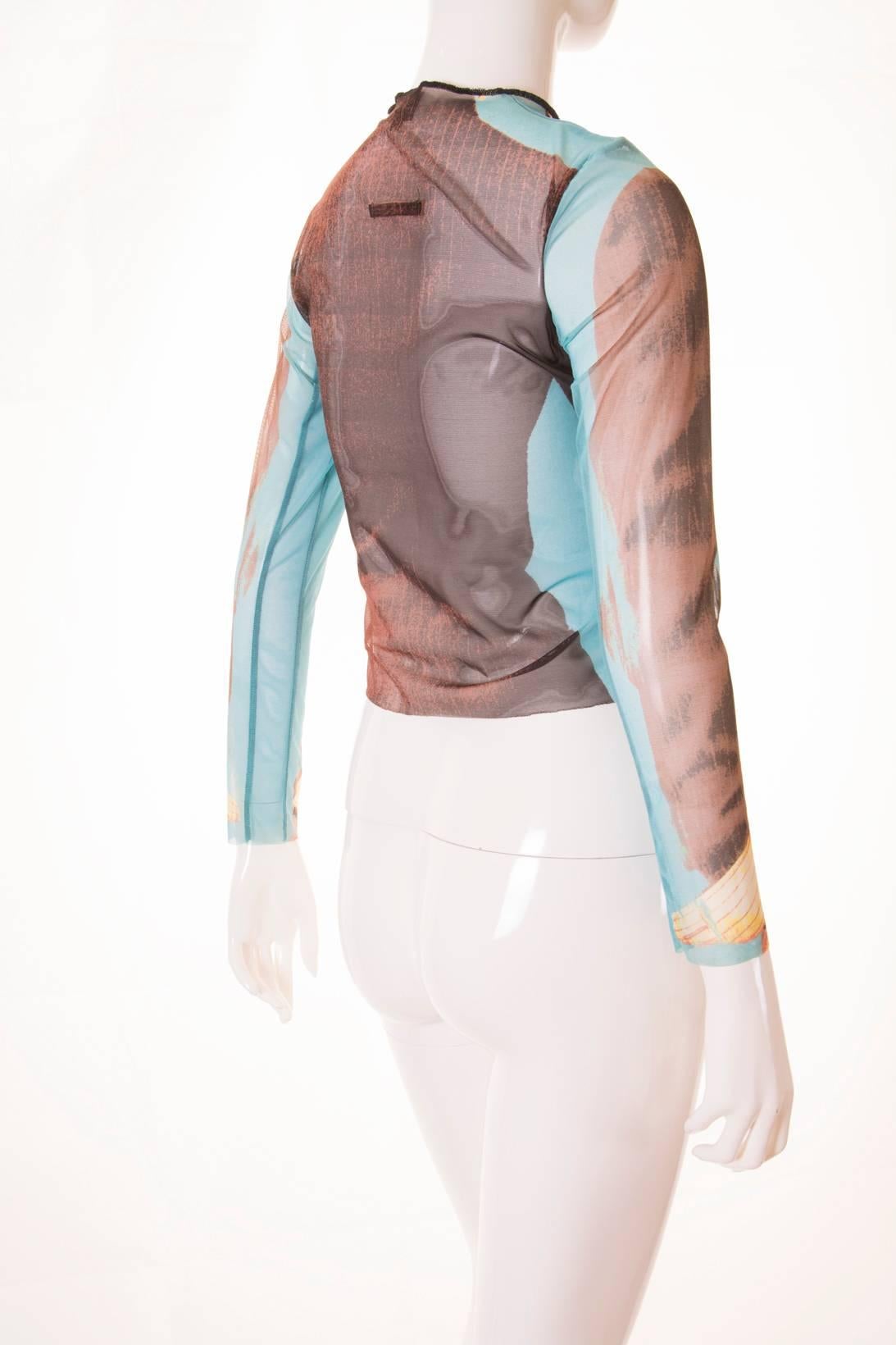 Any item with a visual gag is in automatic yes for us, so we knew we simply had to have this Jean Paul Gaultier top for our store. This sheer women's top has a women's tuxedo with pearls and a rose on the pocket printed on it. Would look amazing
