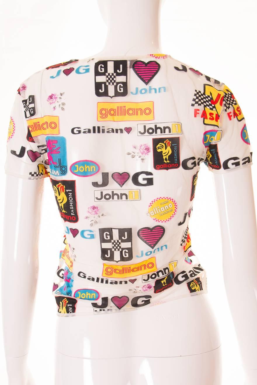 This fun top by John Galliano is made of sheer white mesh and is covered in logos in a Formula 1 inspired design.  This tshirt is fairly fitted and looks great paired with a bold coloured mini for a night time look.  Circa late 90s.  

Underarm