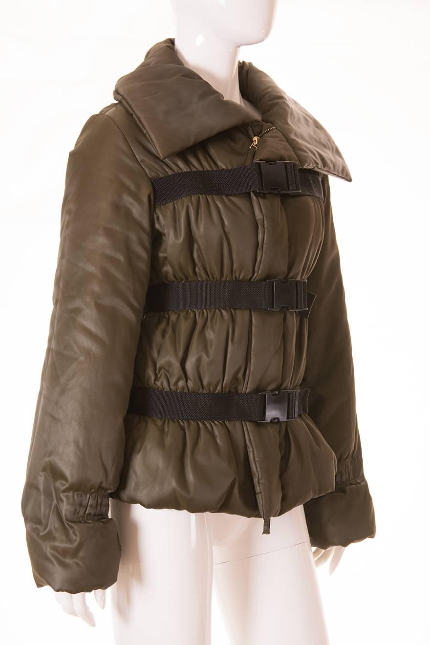 This jacket is a 90s era design by JPG.  Olive puffer coat with adjustable clasps at the front of the jacket.  Huge collar.  Ruching at the front and back of the jacket.  This piece looks incredible on.  Pair it with a skin tight pair of leather