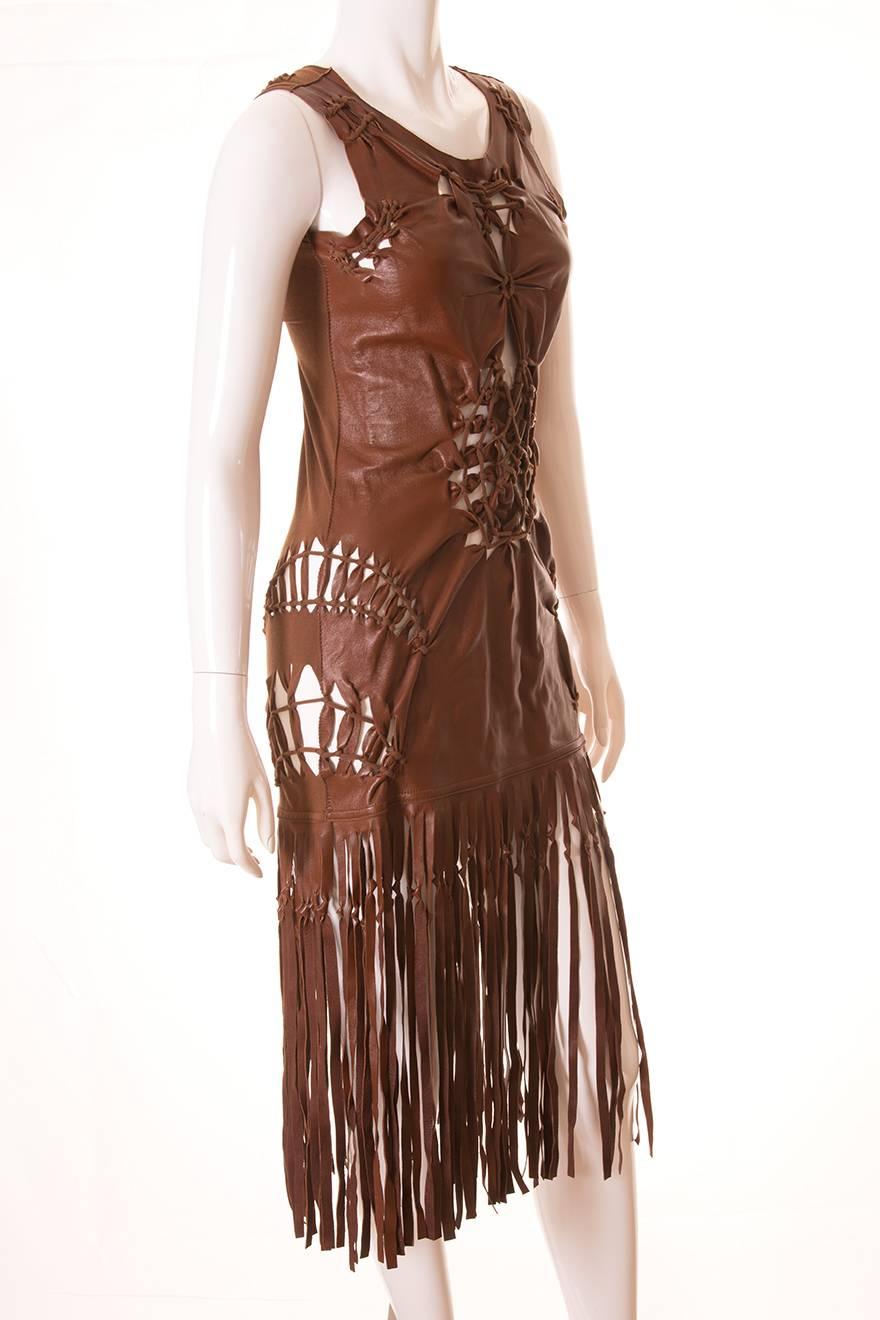 This dress by Jean Paul Gaultier is a showstopper.  The front panel of the dress is made of leather, and the back is made of stretch cotton.  At the hem is a long leather fringe.  There are strategic cut outs all over the dress, which are held