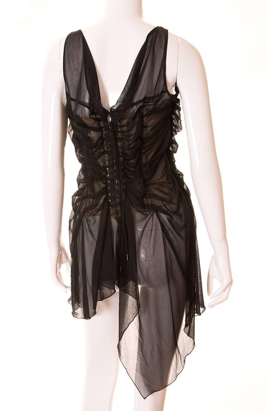This top by Jean Paul Gaultier consists of a nude corset, covered by ruched sheer fabric.  The corset laces up at the back of the top.  Jean Paul Gaultier famously popularised the 