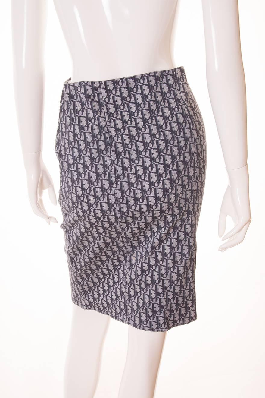 High waisted pencil skirt by Dior in a classic monogram print in a grey-blue colourway.  Split at the back of the skirt.  Circa early 00s.

Marked size 38 (FR)
Waist - 33.5 cm
Hips - 44 cm
Length - 57.5 cm
Please note there is an amount of