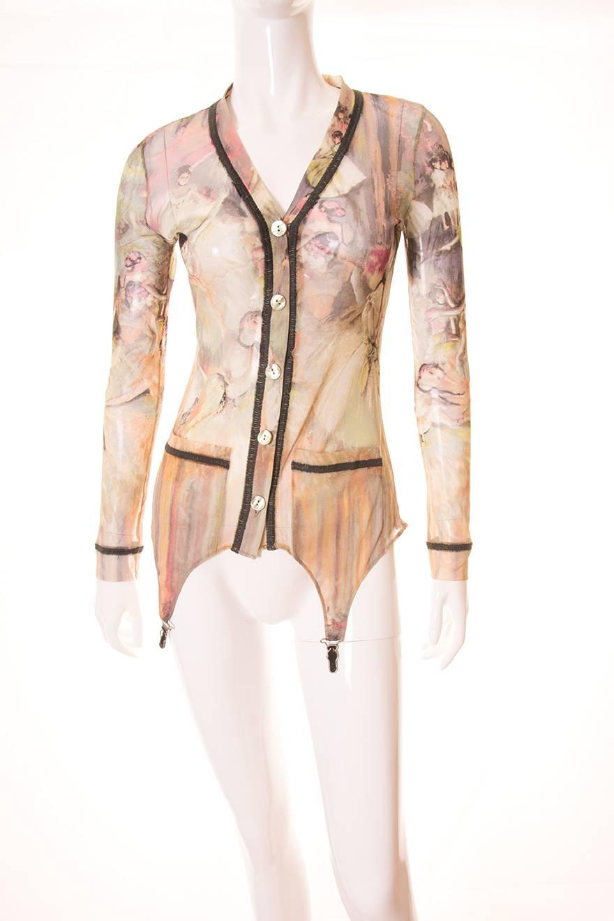 Sheer, pastel toned top by Jean Paul Gaultier featuring a print inspired by the artwork of Edgar Degas.  The top has actual suspender hooks at the bottom.  This piece is made in a deconstructed style; there are raw hems on the front pockets and