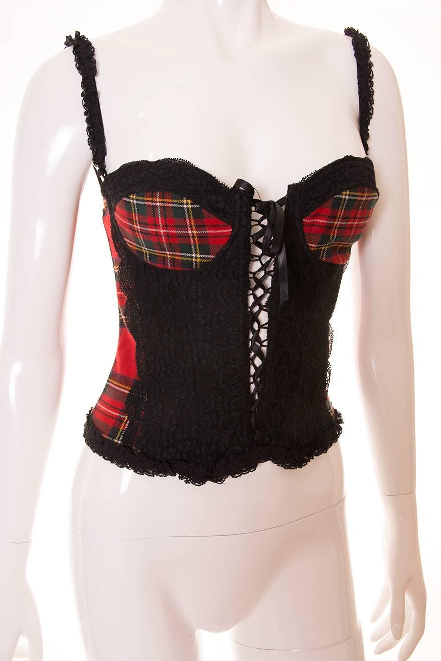 We're really feeling the punk influence on this lace and tartan bustier by Dolce and Gabbana. The front of the top features a lace up ribbon closure. Articulated bust cups. Black lace panel at the front. Lace trim at the bottom and on the stripes.