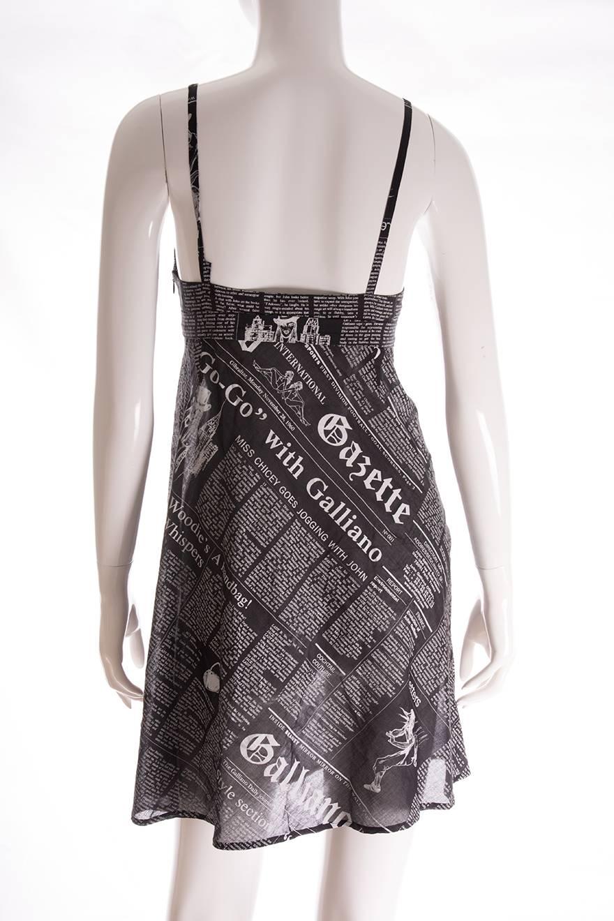 Spaghetti strap mini dress by John Galliano in his iconic newspaper print.  The dress features a metal clasp at the bust and has a baby doll style fit.  Slightly sheer and airy cotton, perfect for summer.  Circa 2000.  

Marked size - 38 (FR),
