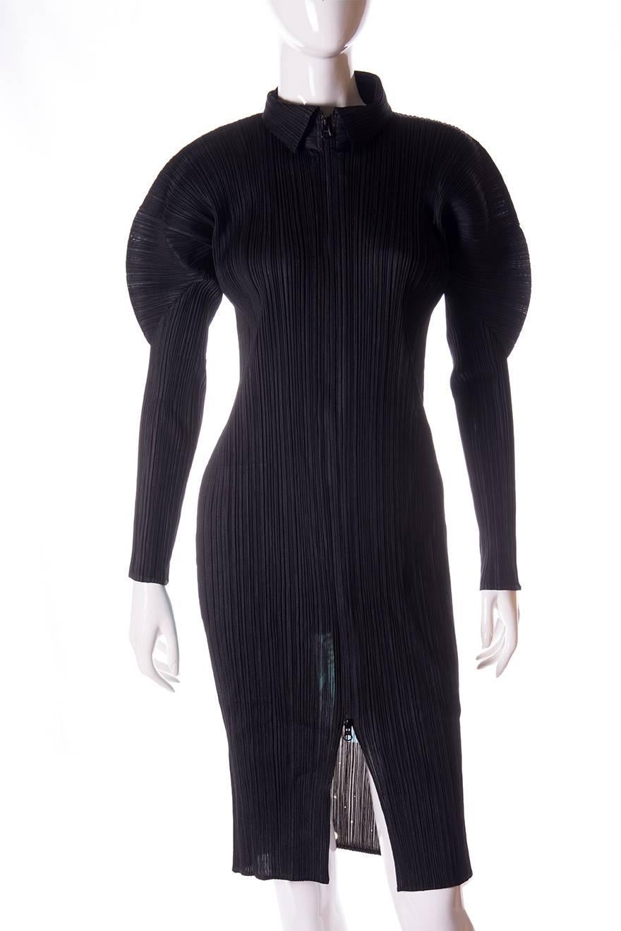 This long sleeved dress by Issey Miyake Pleats Please features an incredible space themed print on the back.  The text at the back of the dress says “Mystery X Pleats Please” and there is a pop art style image of an astronaut in space.  The dress is