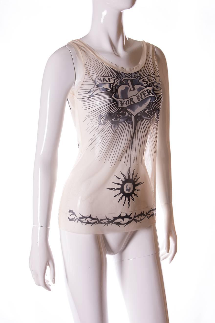 This top is made from sheer, skin coloured fabric so that it gives the illusion the wearer is tattooed. The tattoo inspired print features barbed wire, a heart with a sword through it and a huge Chinese dragon across the back, along with the slogan