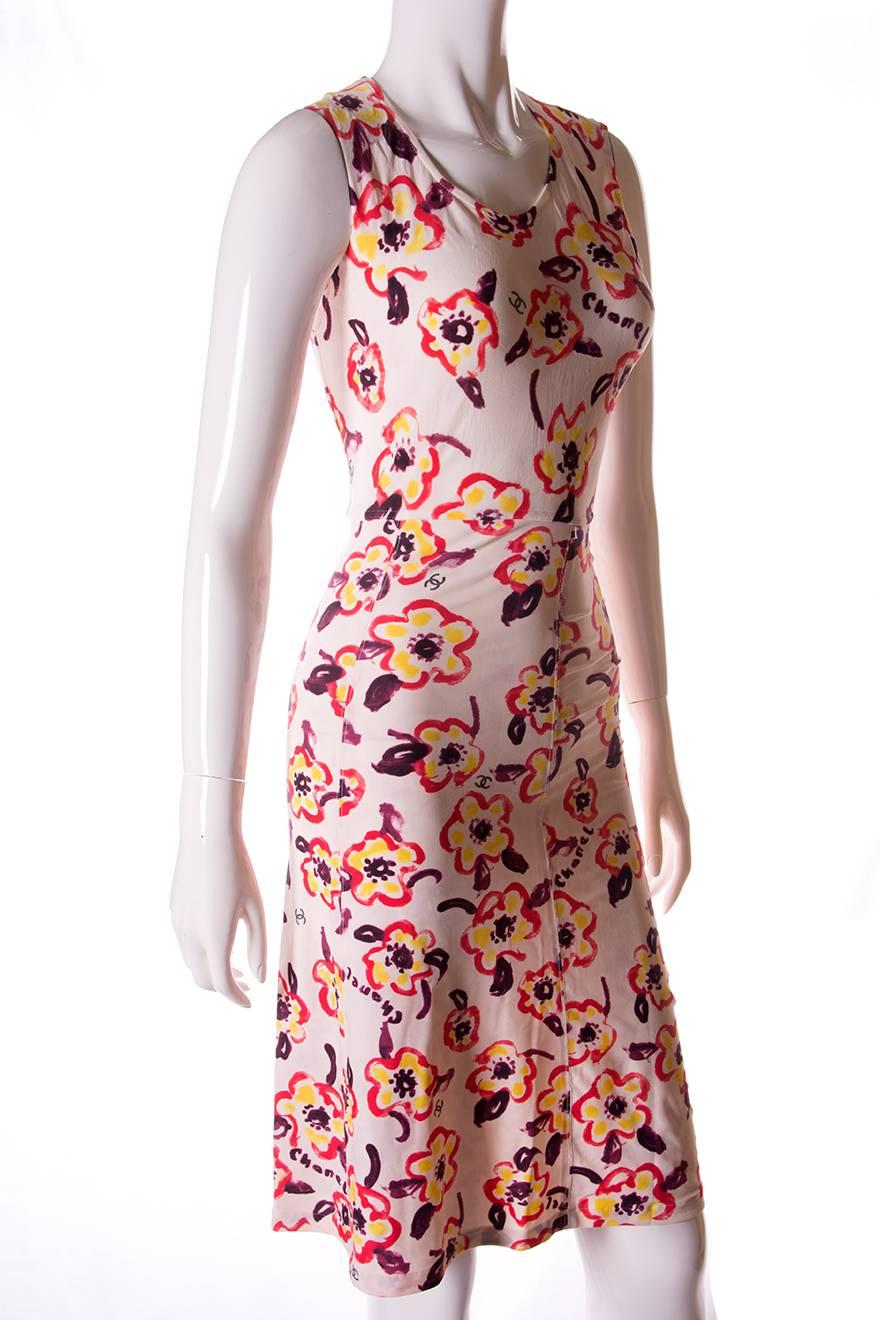 An iconic print by Chanel.  The same print was worn by Amber Valletta in campaign images for S/S 1996.  Stretchy dress with painted camellias and the CC logo

Very good vintage condition.  There are no actual stains or marks on this dress, however