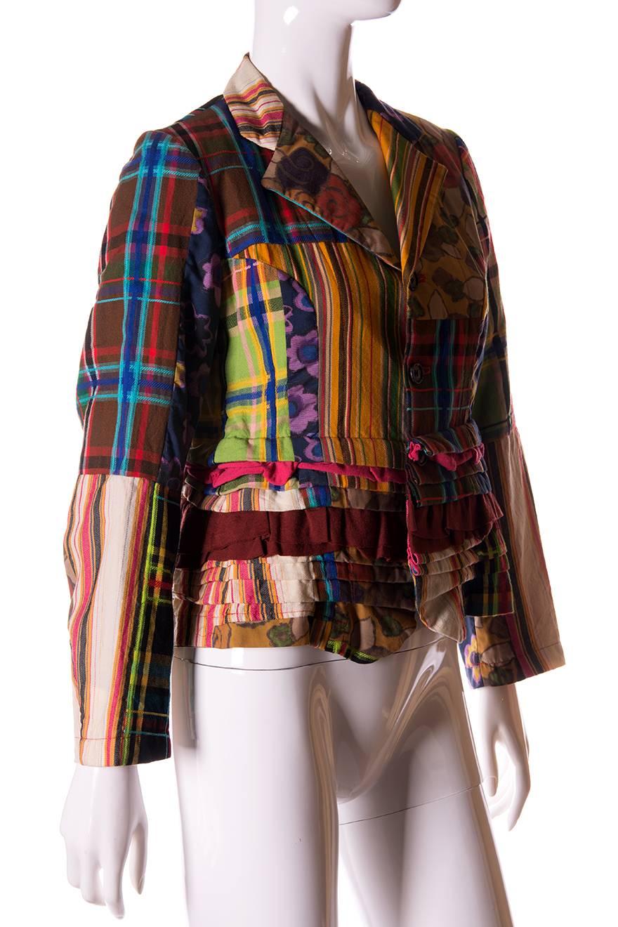 Incredible patchwork blazer by Comme Des Garcons in contrasting fabrics in plaid, stripes and florals.  Deconstructed style.  Single breasted.  This jacket is by Comme Des Garcons Robe De Chambre line.  Circa 90s.

Marked size - M
To fit -