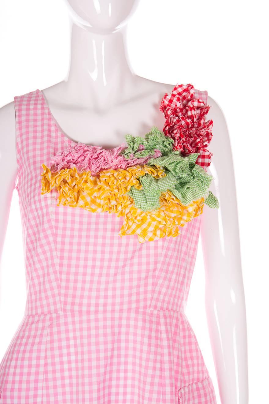 Gingham sundress by Comme Des Garcons, circa late 90s.  Mid calf length.  Two flaps of fabric at the front of the dress.  Gingham ruffles at the neckline.  

Chest: 46 cm
Waist: 36 cm
Length: 112 cm

No marked size.  To fit S-M

This piece